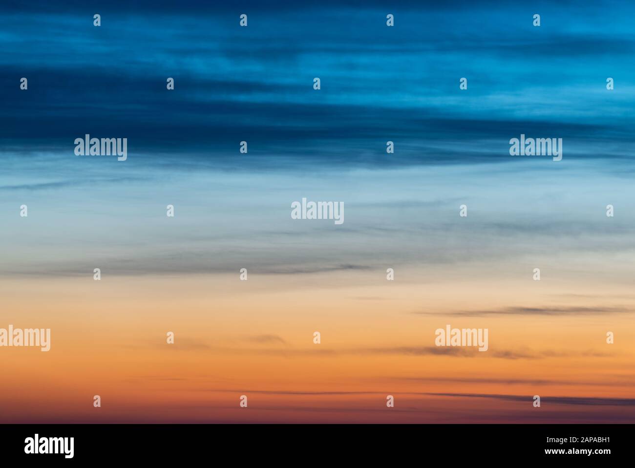 Dramatic sunset sky with blue-orange colored clouds Stock Photo - Alamy