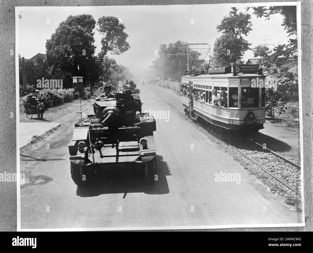 Batavia. Entry British troops with Stuart tanks. On the right a tram line 5 (Jembatan Merah/Ramat - Tanah Abang) Date: September 1945 Location: Batavia, Indonesia, Jakarta, Dutch East Indies Keywords: military, tanks, World War II Stock Photo
