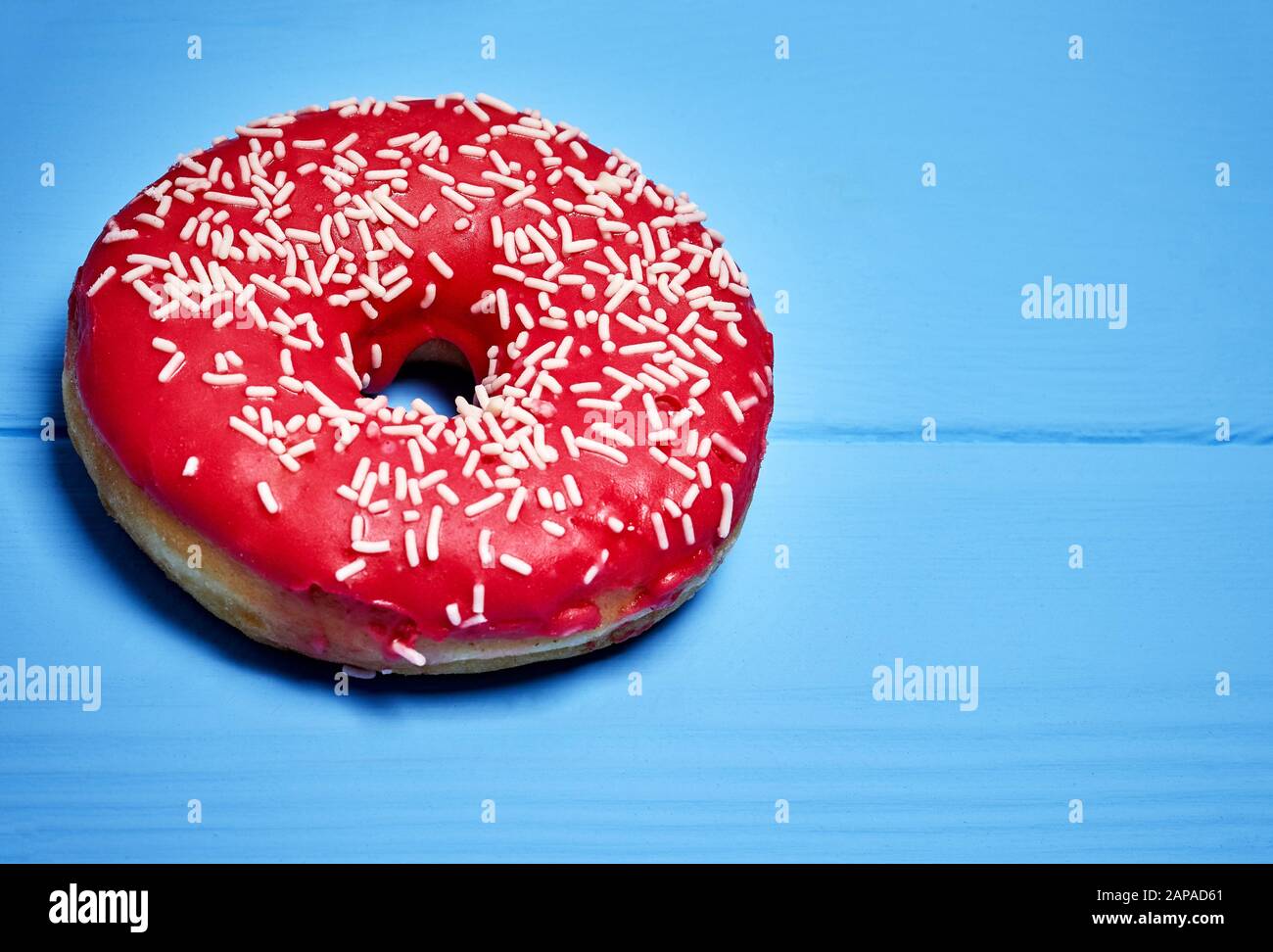 pink glazed donut on a blue background Stock Photo