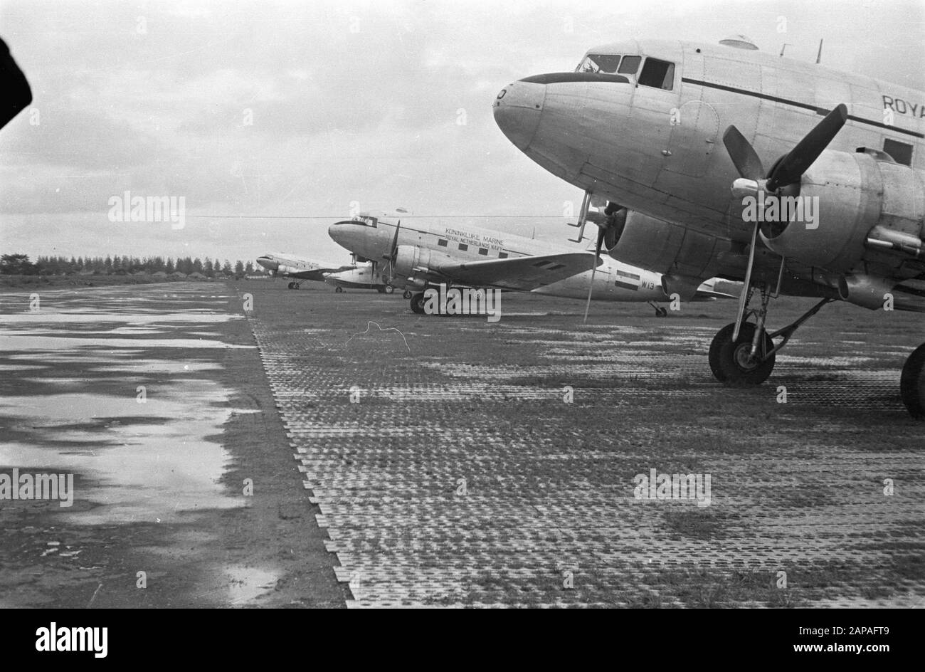 Airbases Description: Dakota's (Douglas C-47) of the Royal Navy at an airport Annotation: Possibly Padang (had concrete runways) Airplane left has registration number W 13 Date: april 1947 Location: Indonesia, Dutch East Indies Stock Photo