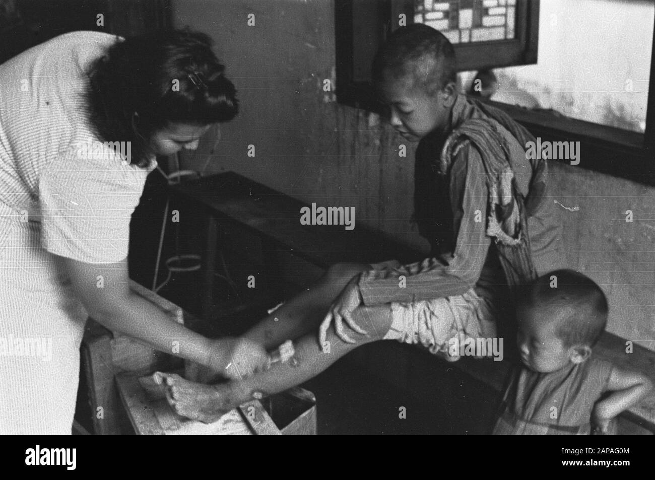 Red Cross activity [Semarang] Description: The legs of a boy are taken ...