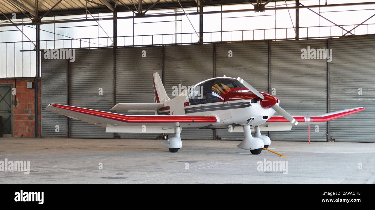 A small plane, parked in hangar airplane in a airport. Stock Photo