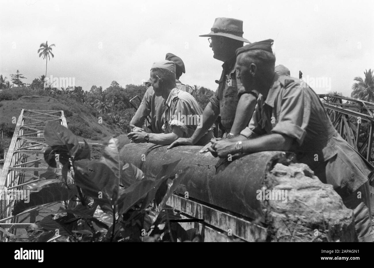 Lahat Description: The Territorial also Troop Commander of South Sumatra, Colonel F. Mollinger (with bushhat) discusses with Lieutenant Colonel H.G.M. Bouwman (left) the situation at the bridges destroyed by Republicans for Tebing Tinggi Date: 19 December 1948 Location: Indonesia, Dutch East Indies, Sumatra, Tebing Tinggi Stock Photo