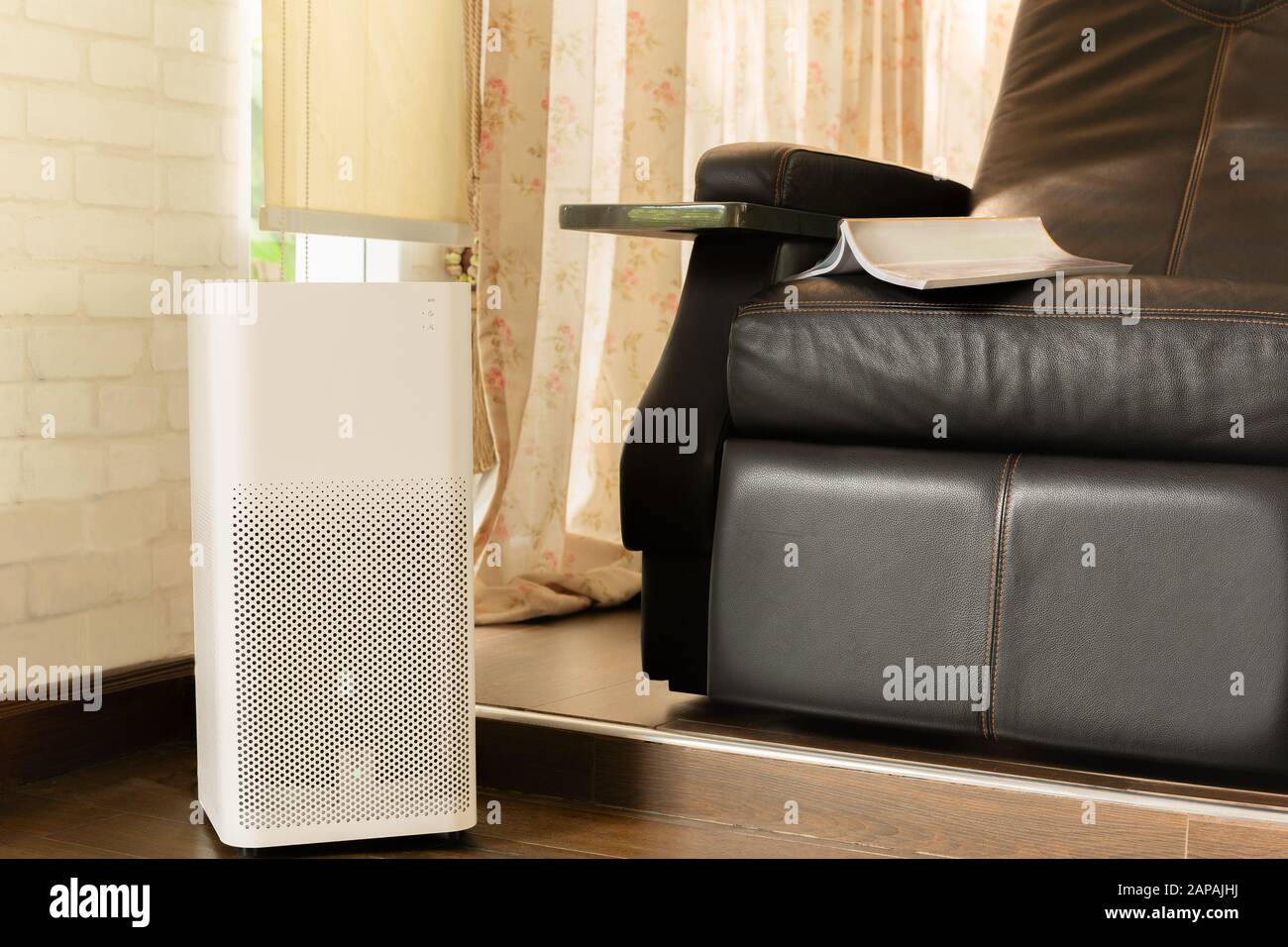 Electric air purifier in a living room for cleaning fine dust in house