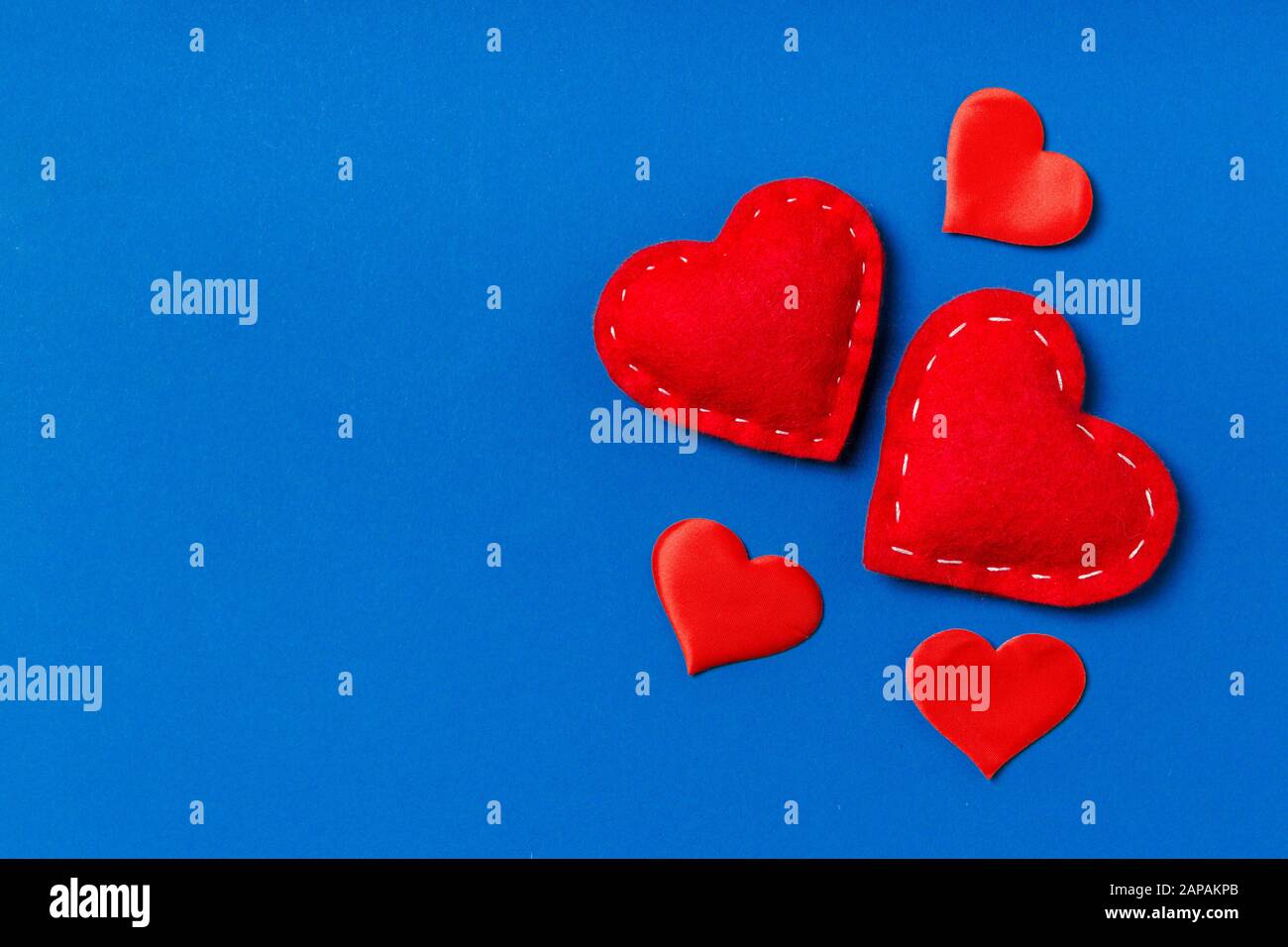 Top view composition of red hearts on colorful background. Romantic relationship concept. Valentaine's Day. Stock Photo