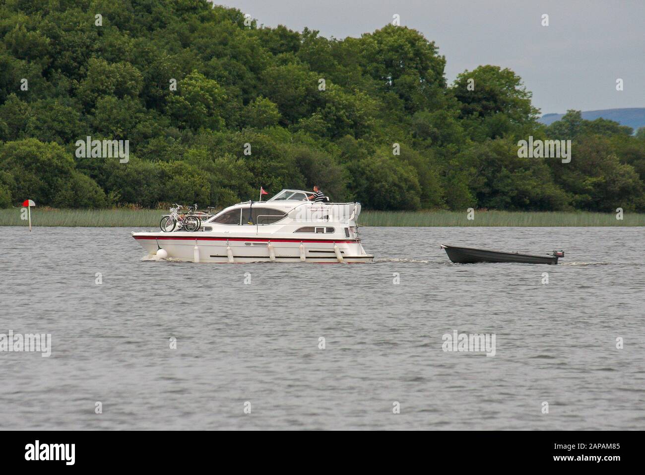 A cruising holiday on Lough Erne, Northern Ireland with an Aghinver white motor cruiser crossing the lough with bicycles onboard boat. Stock Photo