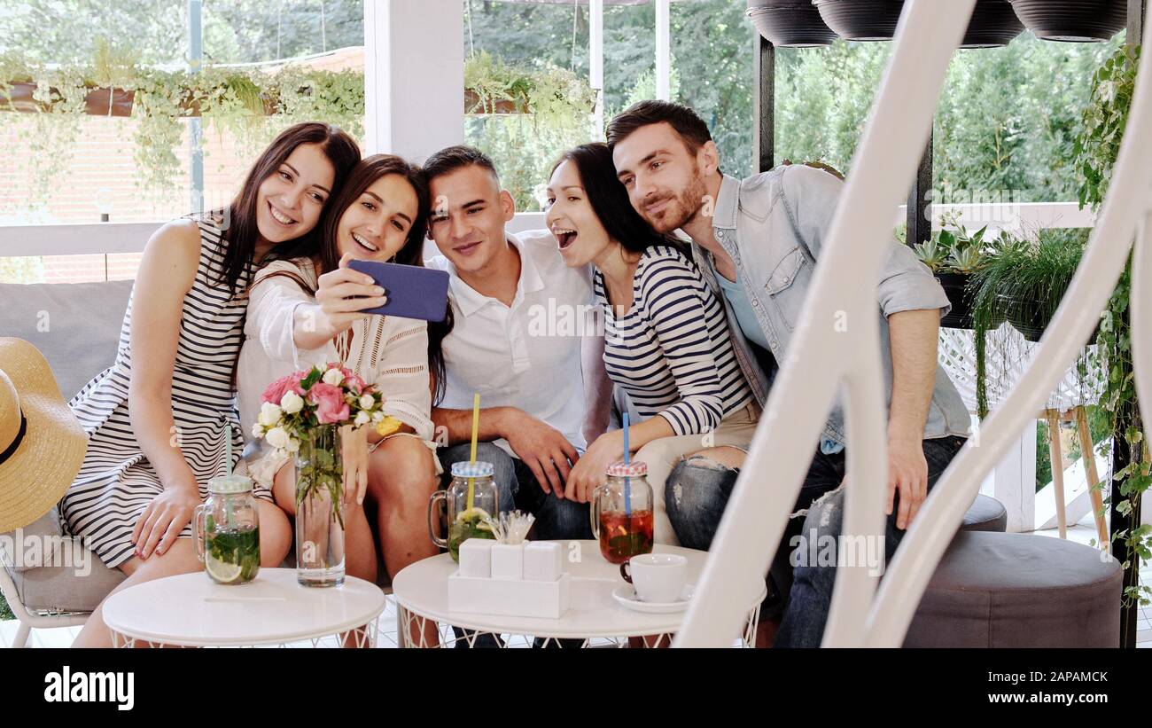 Group of friends makes selfie in at cafe. Friends enjoying together at cafe Stock Photo