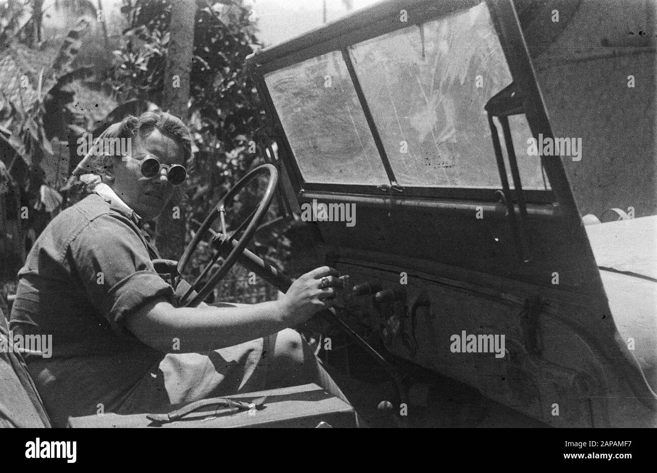 Driver of a jeep with glasses Date: 1947/01/01 Location: Indonesia, Dutch East Indies Stock Photo