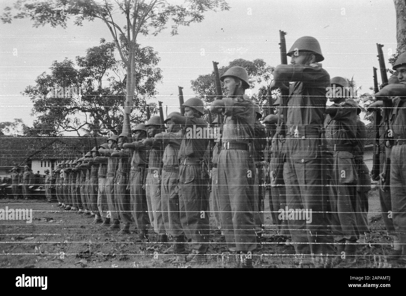 Swearing. KNIL troops stand in office Date: 1947 Location: Indonesia, Dutch East Indies Stock Photo