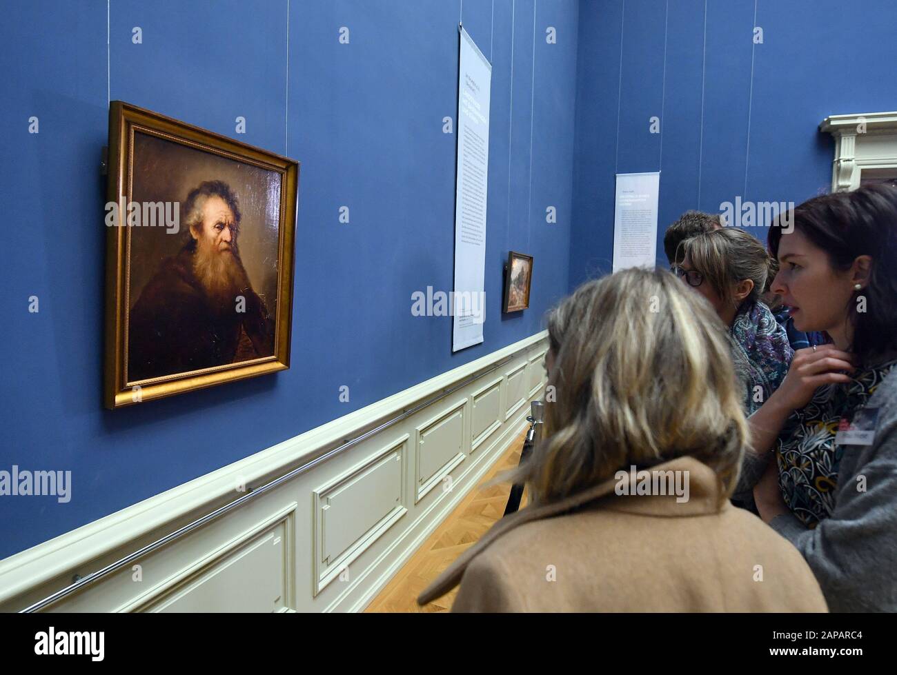 20 January 2020, Thuringia, Gotha: Visitors look at the painting 'Old Man' by Jan Lievens (1607-1674). After their theft about 40 years ago, five top-class paintings are being shown again in Gotha. The pictures were considered lost after the mysterious theft in 1979. In 2018 they were offered for sale through a lawyer of the Stiftung Schloss Friedenstein. In September 2019 the works were finally handed over. Now, after completion of investigations into their authenticity and condition, they can be seen for a week. Photo: Martin Schutt/dpa-Zentralbild/ZB Stock Photo