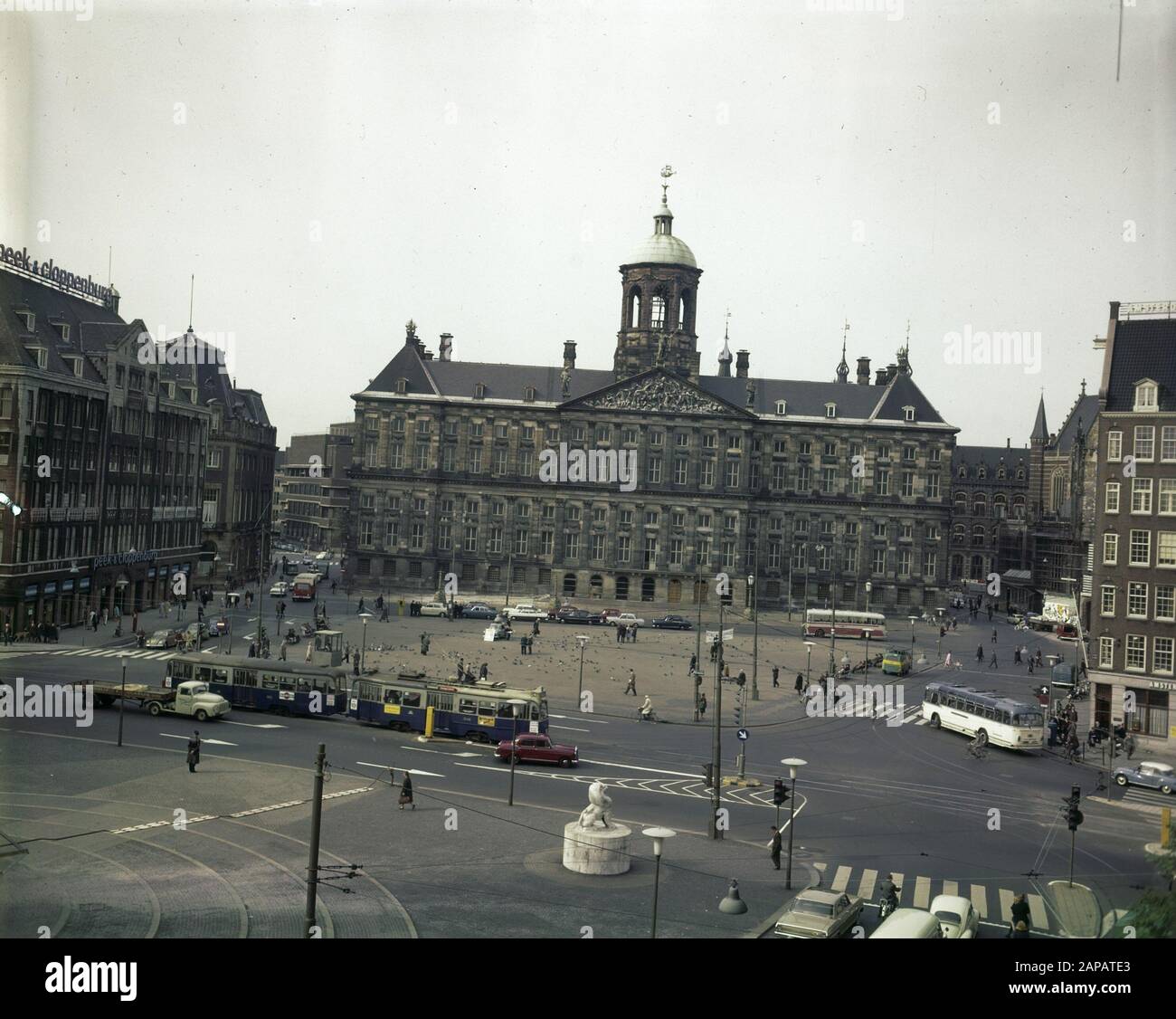 Amsterdam. Dam with the royal palace Date: 29 September 1965 Location: Amsterdam, Noord-Holland Keywords: Baroque, classicism, domes, palaces, squares, cityscapes, trams, traffic Institution name: Palace on the Dam Stock Photo