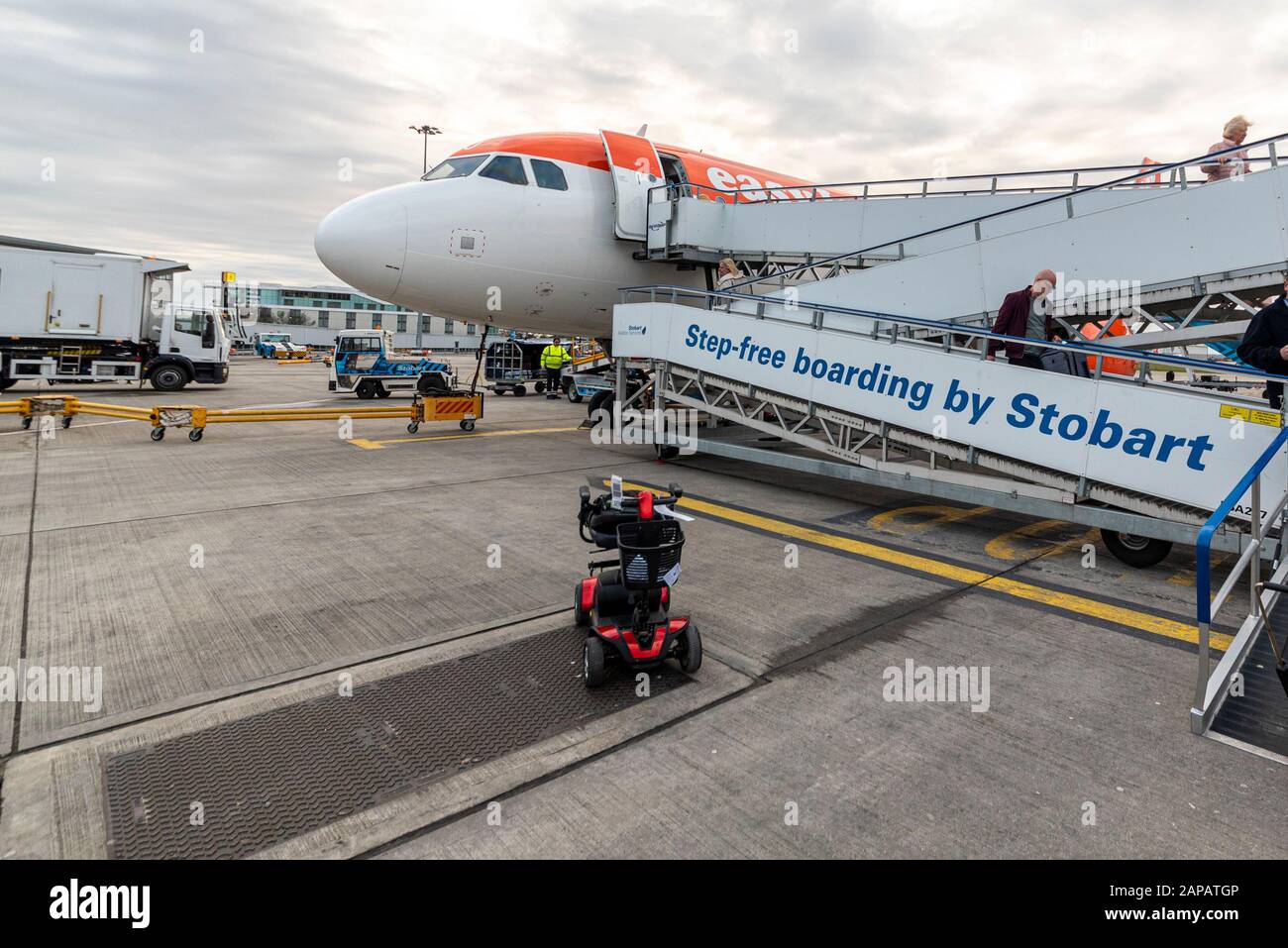 Step free boarding Stobart ramp in use London Southend Airport for an easyJet plane with mobility scooter. Accessible air travel. Disability. Access Stock Photo
