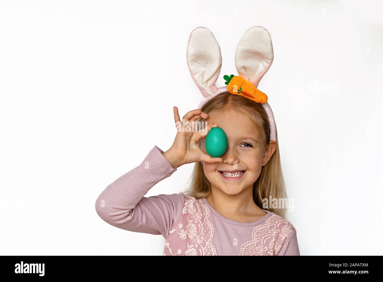 Cute little girl with bunny ears holding Easter egg, isolated on white ...