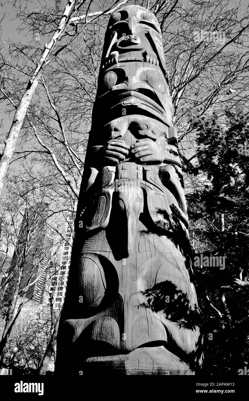 Native American Art in the form of wooden Totem Poles in Pioneer Square, Seattle, Washington State, USA. Shot in black and white. Stock Photo