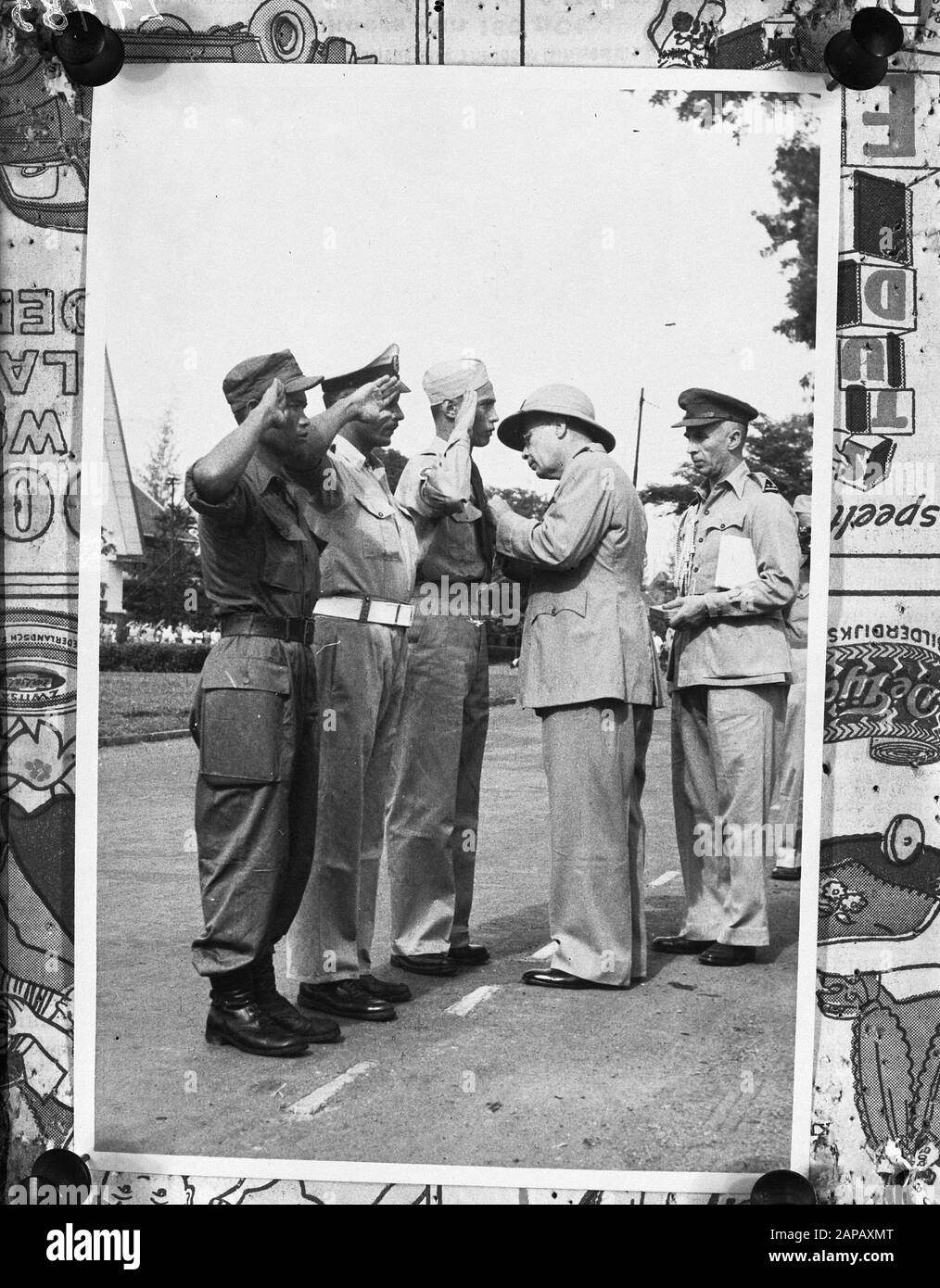 Batavia 28-10-'47. H.E. The Lt. Gouv. Gen. Dr. H.J. van Mook during the presentation of the honorary metal to the decorated, v.r.n.; Oh, Maj. C. Knulst, Kapt. J.C.A. Faber and Javanese Corporal Kemis Bin Panoe. Annotation: Repronegative. See DLC 5684 Date: 28 October 1947 Location: Batavia, Indonesia, Jakarta, Dutch East Indies Keywords: awards Person name: Mook, H.J. van Stock Photo