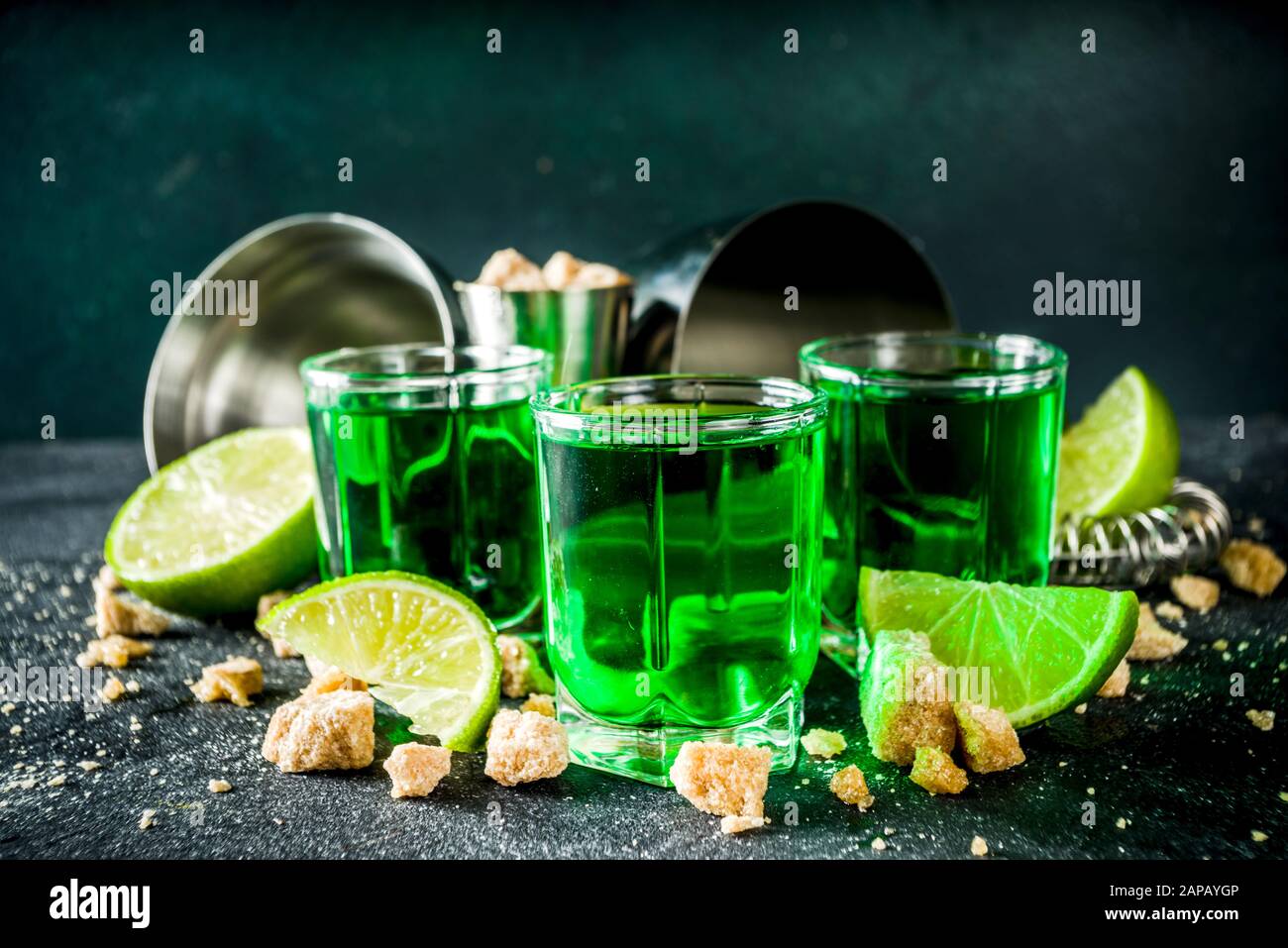 Strong alcohol. Absinthe with sugar, ice cubes and lime slices, Three ...
