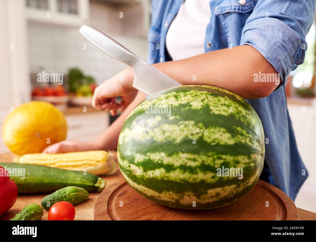 Watermelon and a knife stabbed in Stock Photo - Alamy