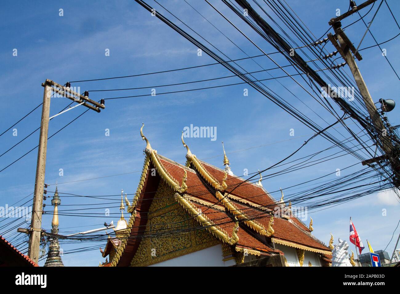 Electrics cables power lines on sky temple Chiang Mai, Thailand Stock Photo