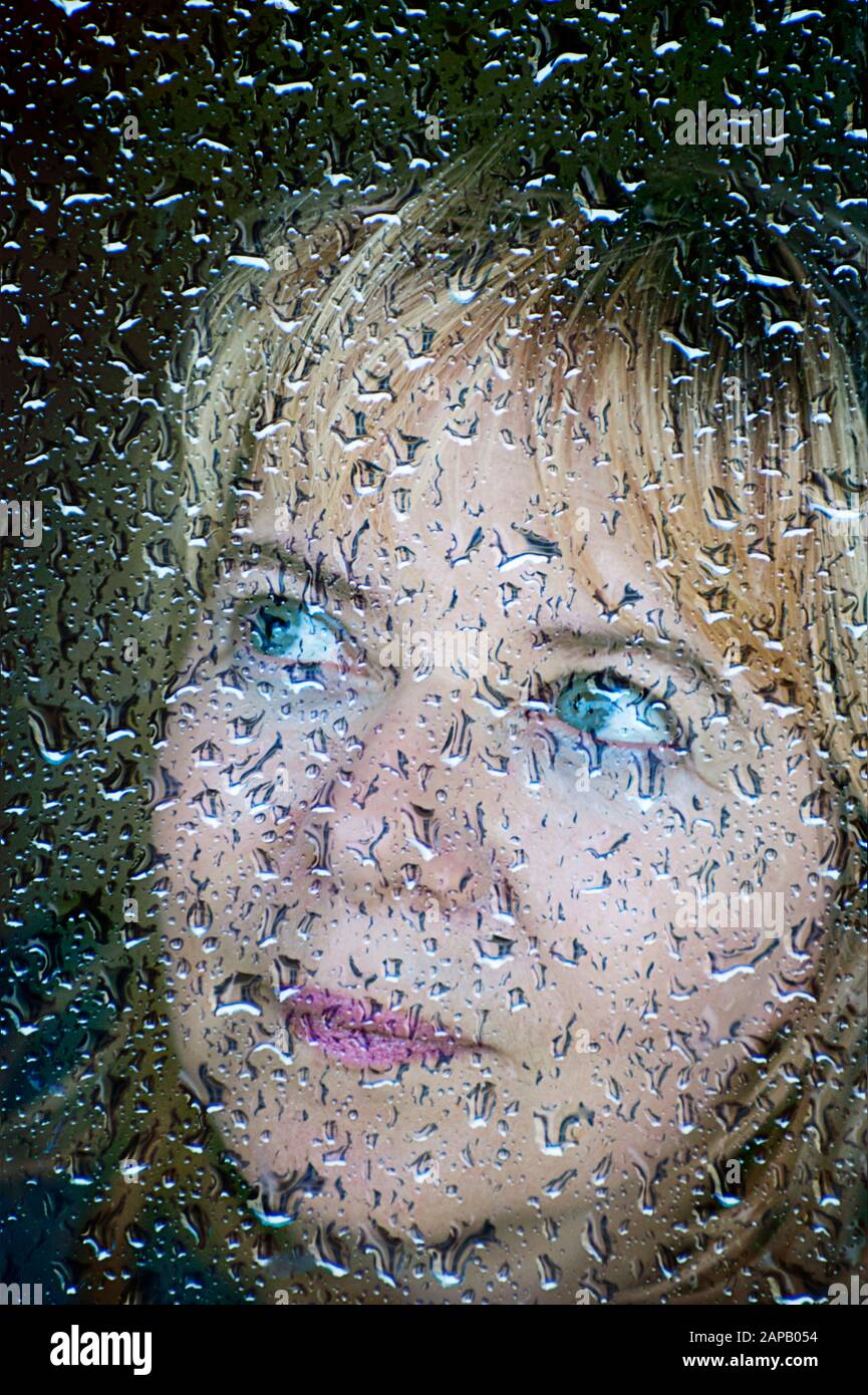 blonde-adult-woman-portrait-behind-a-window-with-rain-drops-2APB054.jpg