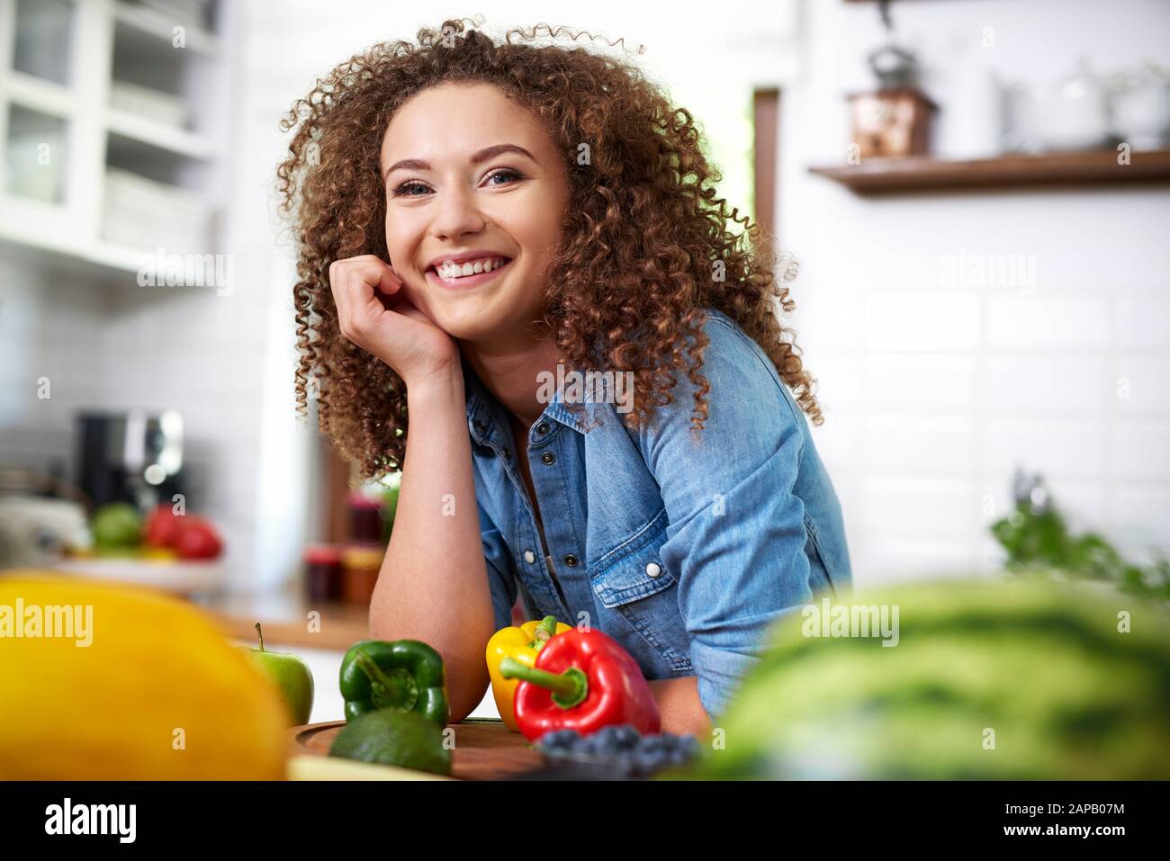 Portrait of young woman in domestic kitchen Stock Photo