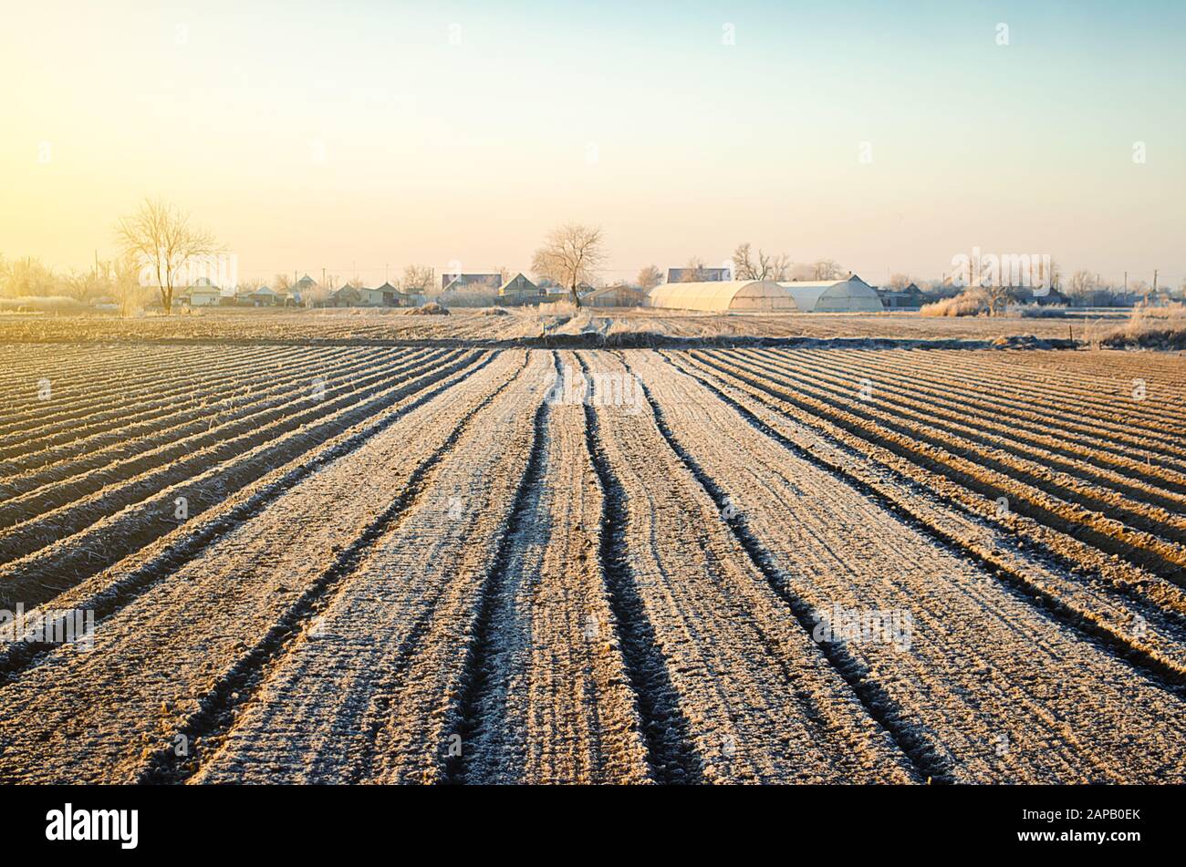 Preparing farm field for spring work and planting season. Choosing right time for sow fields plant seeds, protection from spring frosts. Agriculture a Stock Photo
