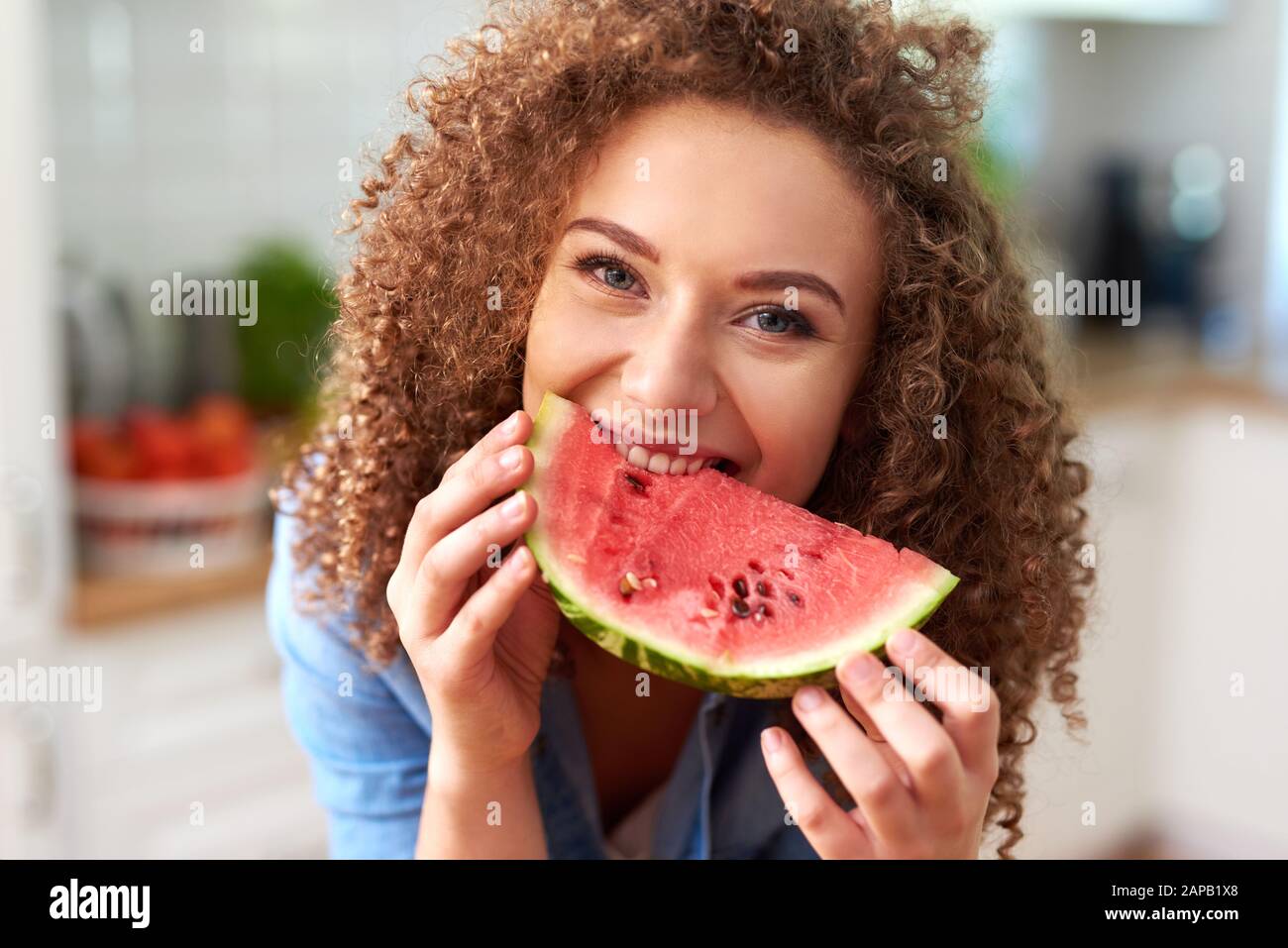 Beautiful woman eating a watermelon Stock Photo