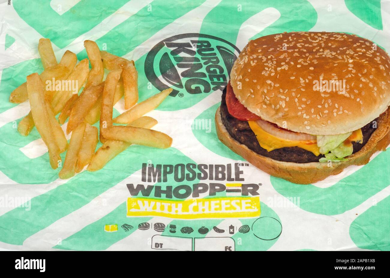 Burger King Impossible Whopper with french fries or chips on wrapper Stock Photo