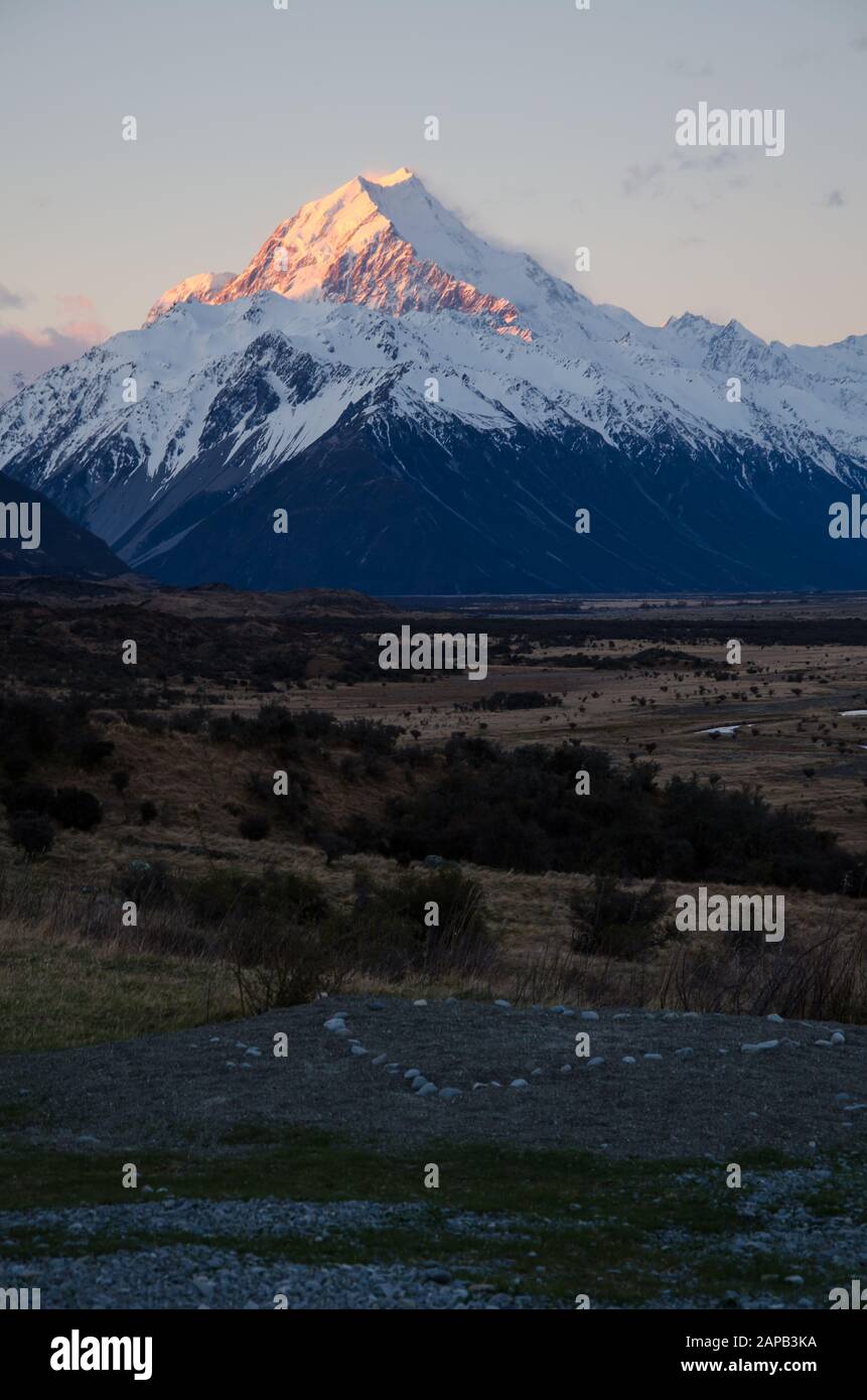 Snow covered Mount Cook with heart in the foreground at sunset golden hour, South Island, New Zealand Stock Photo