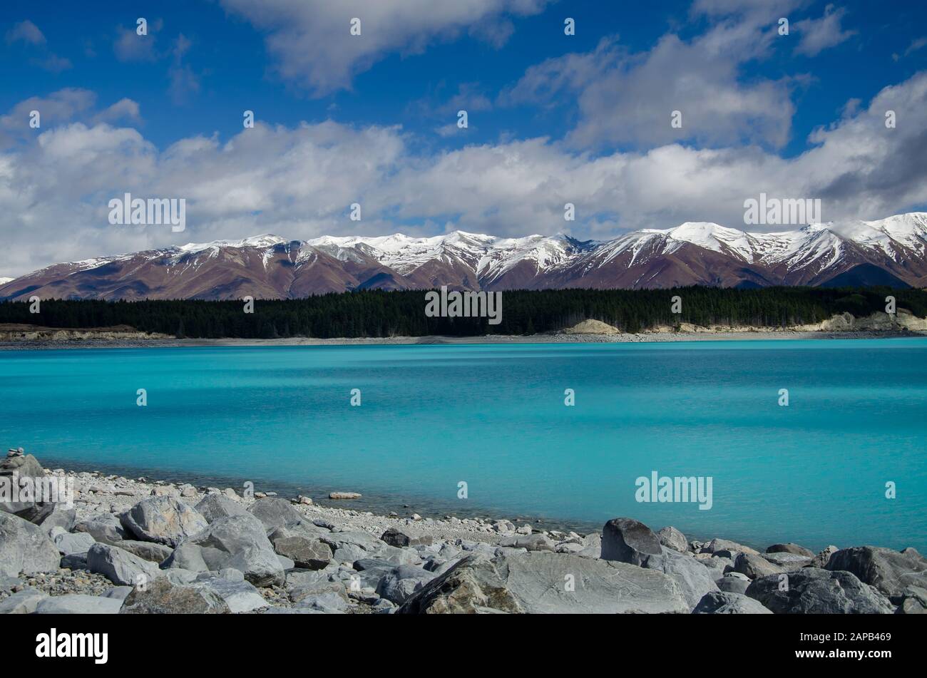 Lake Pukaki with snow covered mountains and blue sky, South Island, New Zealand Stock Photo