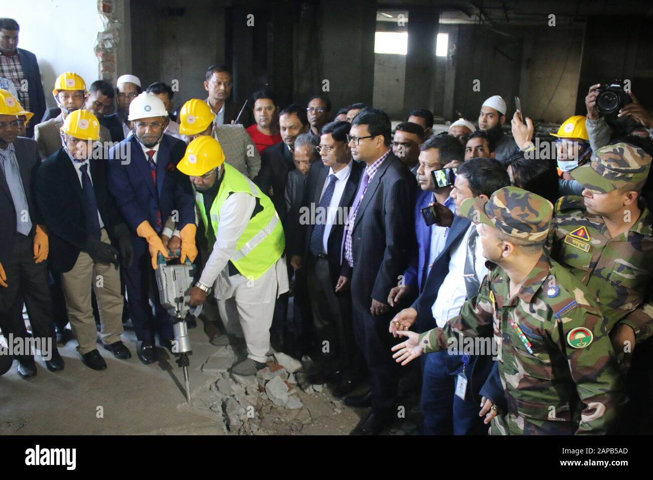 (200122) -- DHAKA, Jan. 22, 2020 (Xinhua) -- Bangladeshi Public Works and Housing Minister SM Rezaul Karim (3rd L, front) inaugurates the demolition activities of the 'illegally constructed' 16-storey headquarters building of BGMEA (Bangladesh Garment Manufacturers and Exporters Association) in Dhaka, Bangladesh on Jan. 22, 2020. TO GO WITH 'Roundup: Bangladesh demolishes apparel exporters' headquarters building in Dhaka' (Str/Xinhua) Stock Photo