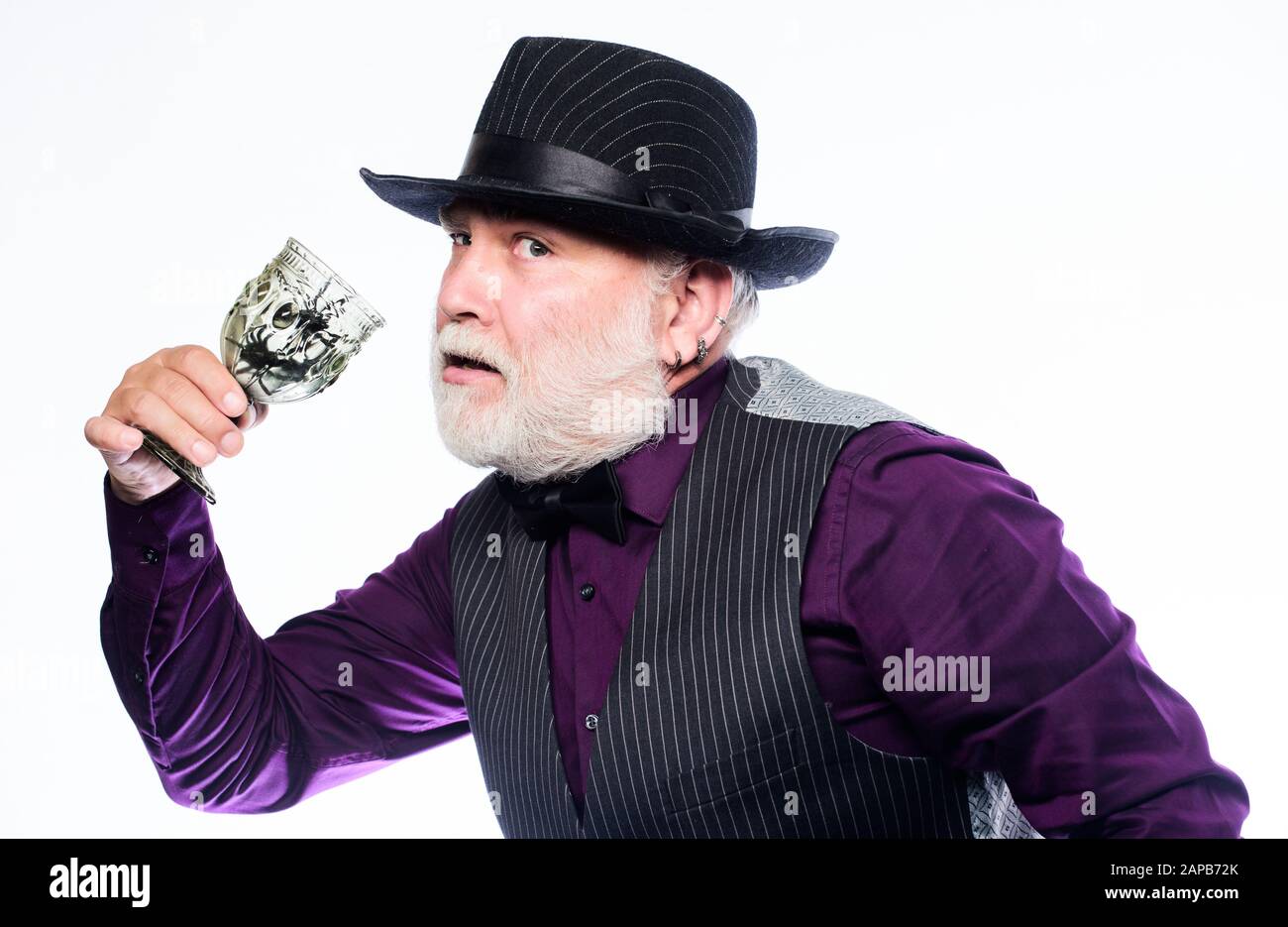 On Halloween night. evil wizard cooking magic potion with spider. mature man magician in witch hat. happy halloween. barman make cocktail for halloween party. halloween holiday costume. Stock Photo