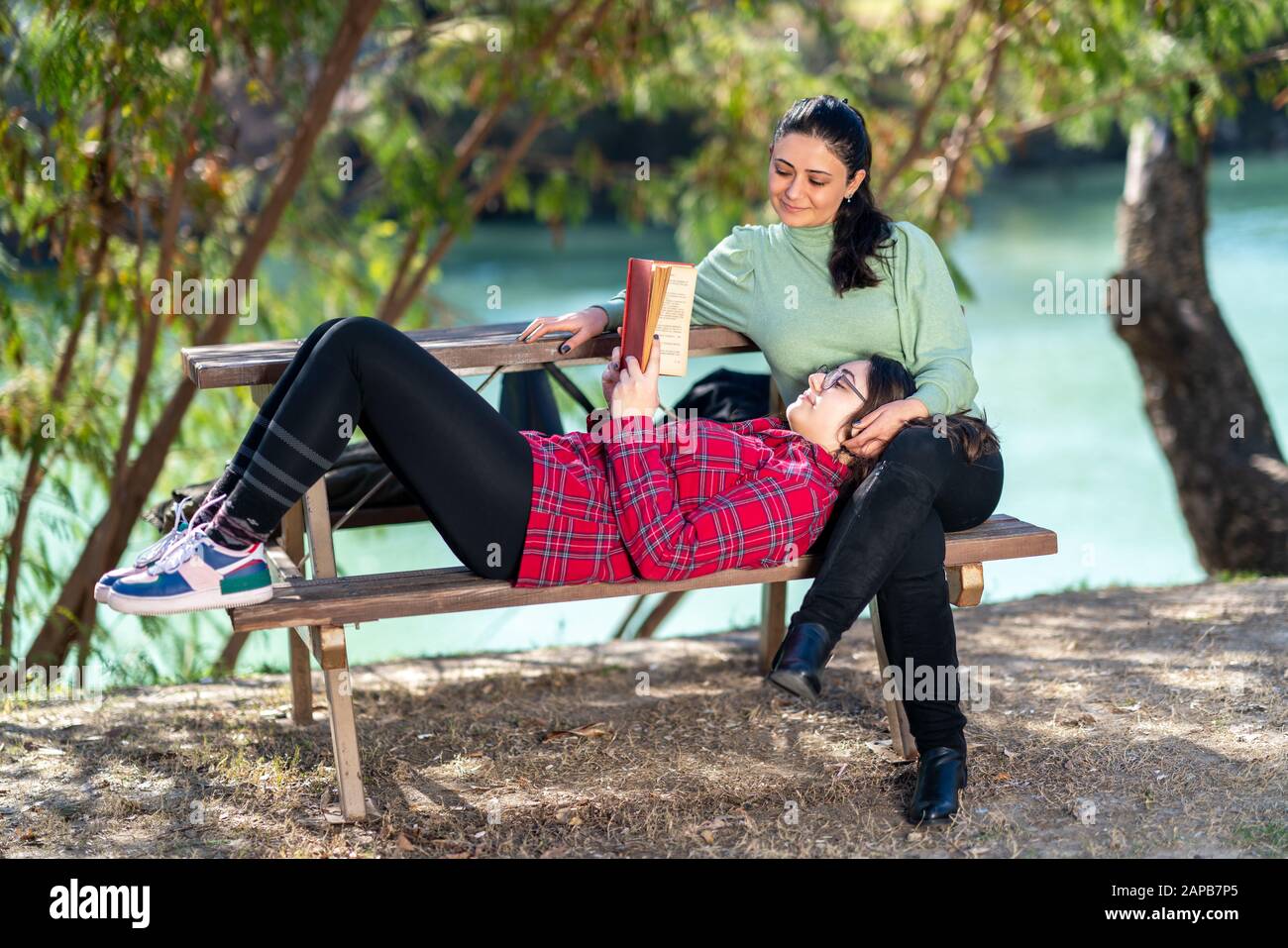 Mother and daughter enjoing their relationship in a park with a nice weather. Stock Photo