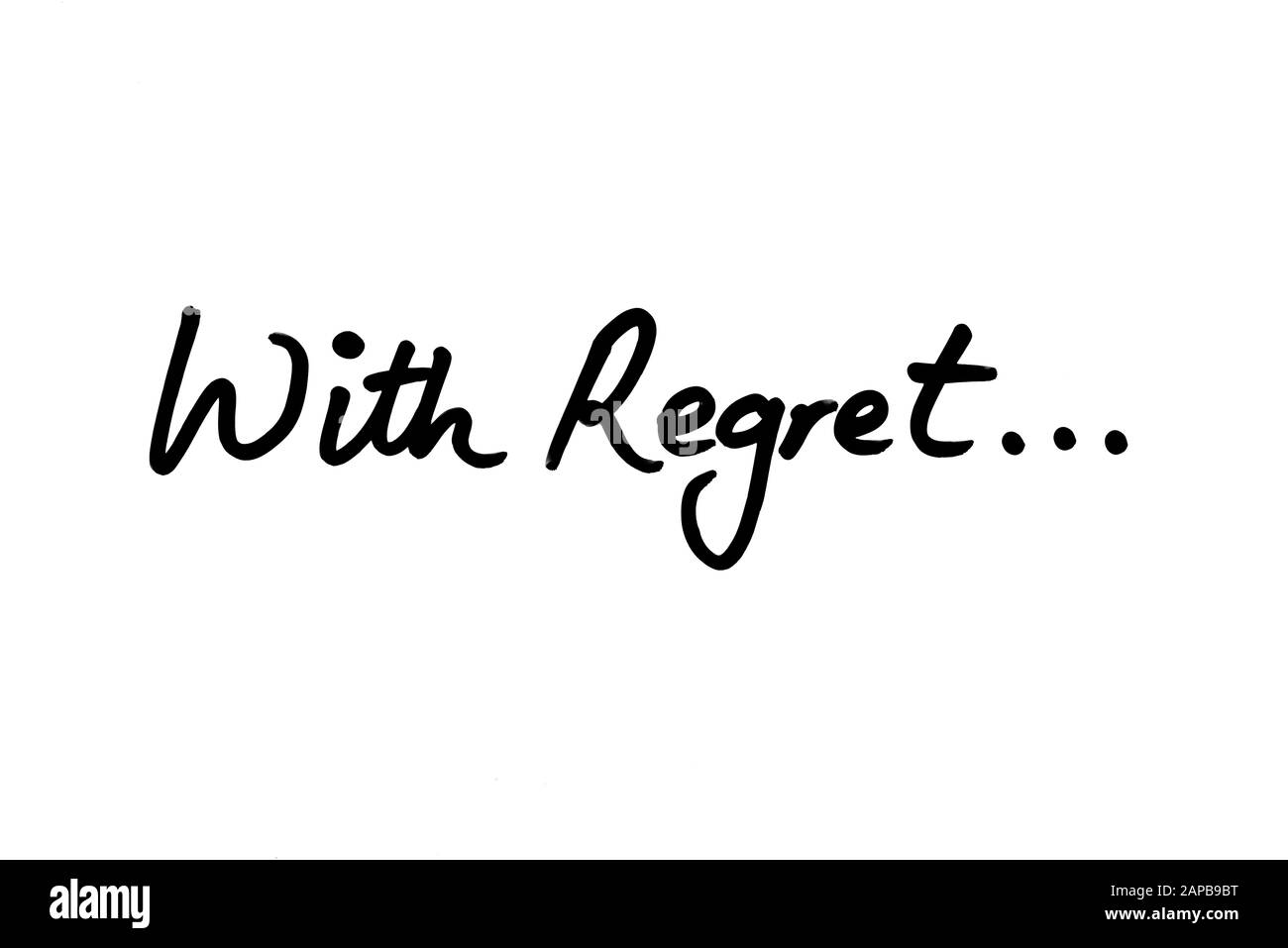 With Regret… handwritten on a white background. Stock Photo