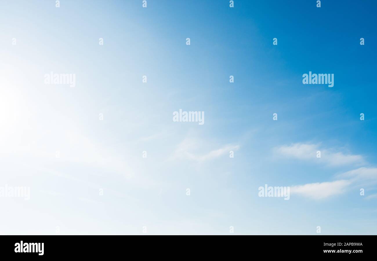 Bright and soft blue sky with small white clouds Stock Photo