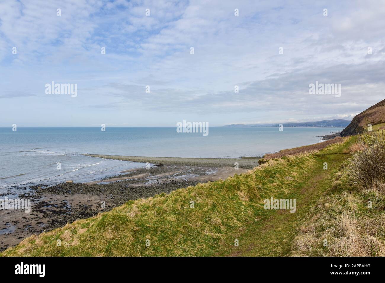 Sarn Wallog, in Welsh called Sarn Gynfelyn stretches out into Cardigan Bay Wales UK Stock Photo