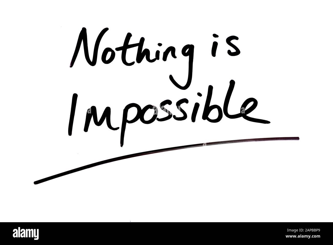 Nothing is Impossible handwritten on a white background. Stock Photo