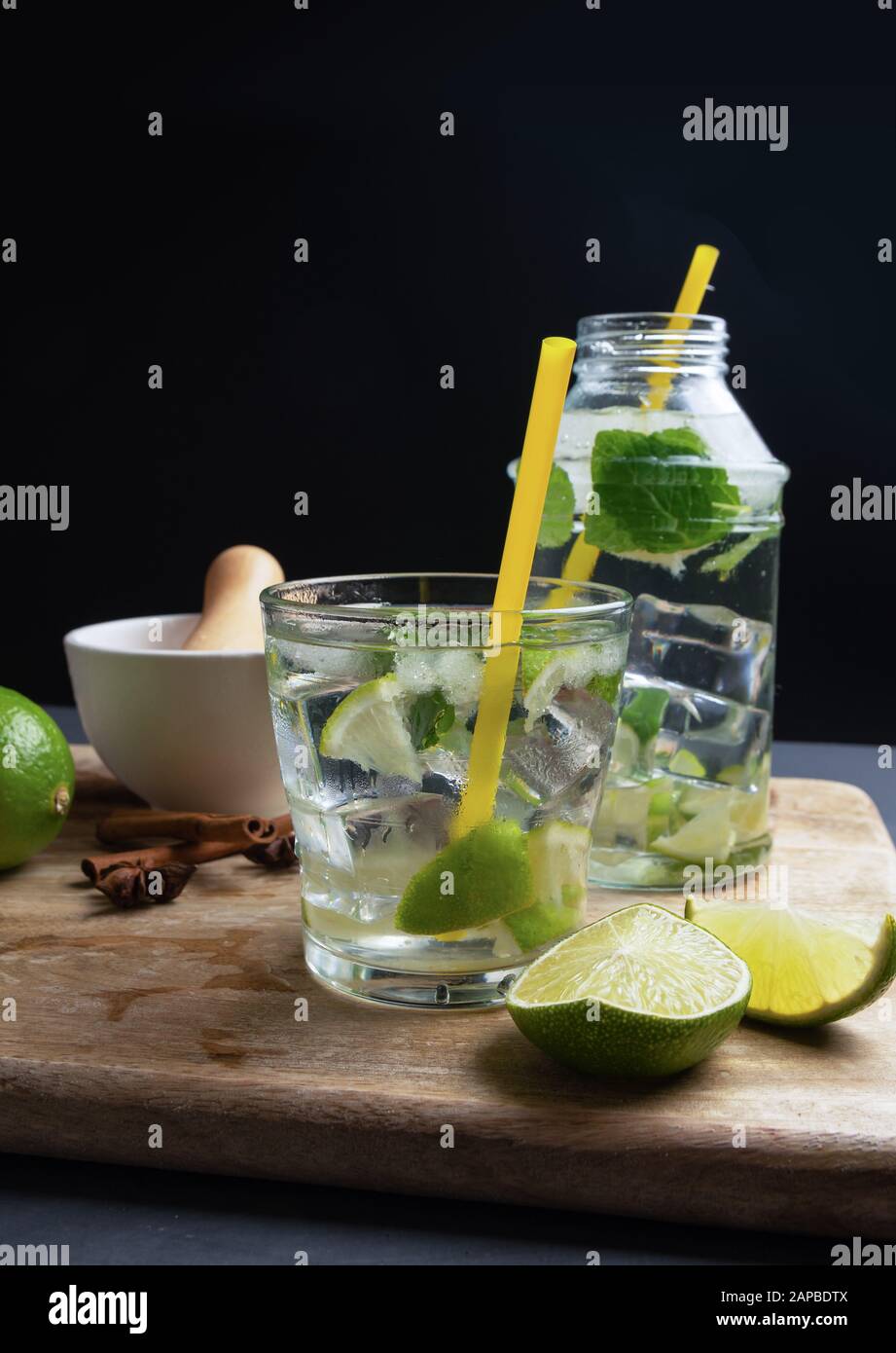 Cachaca caipirinha with lime and chopped ice, space for copying, dark brown sugar and fresh mint, vertical composition Stock Photo