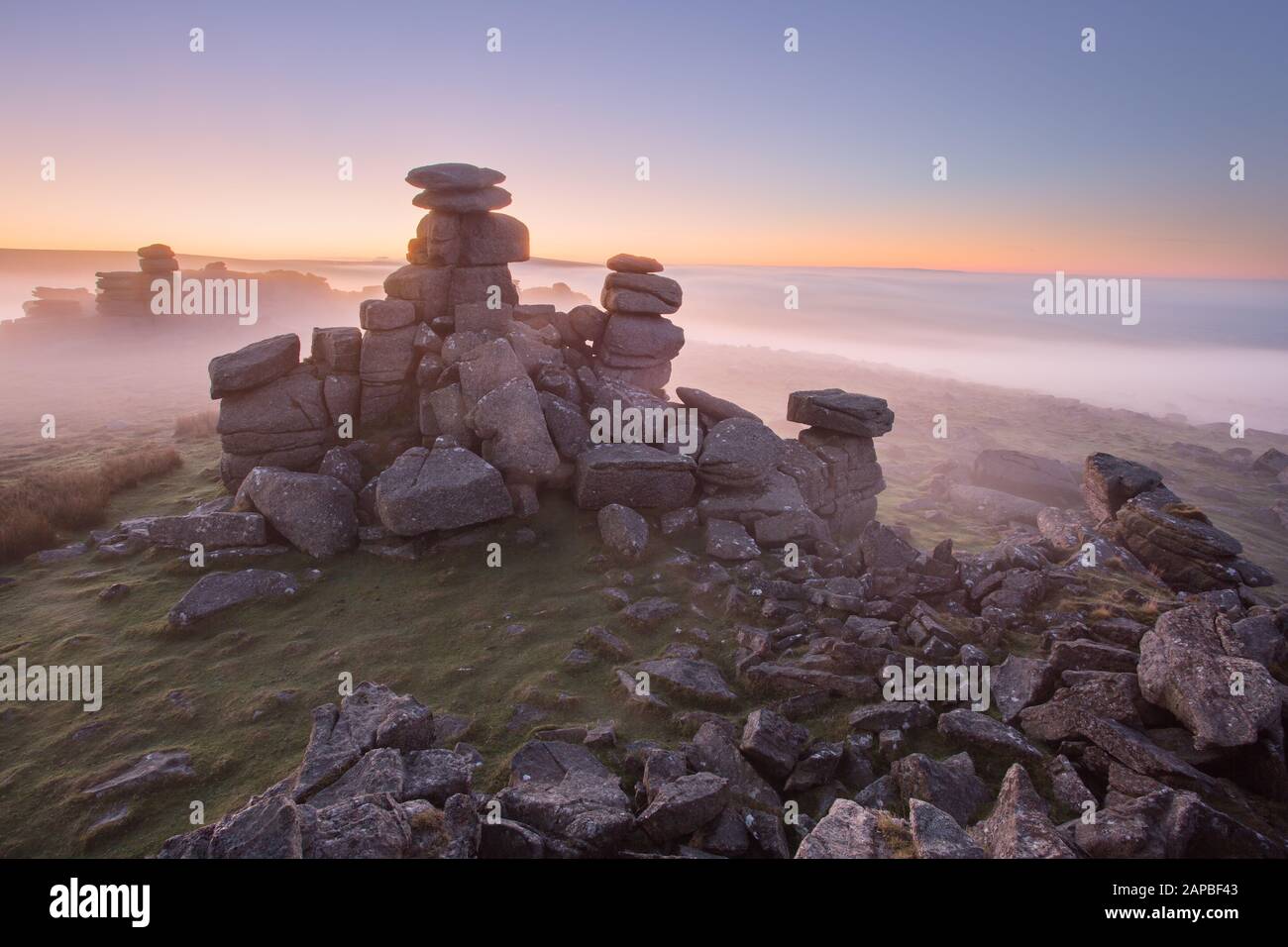 Misty sunrise morning on Staple Tor Dartmoor Devon Uk Stock Photo