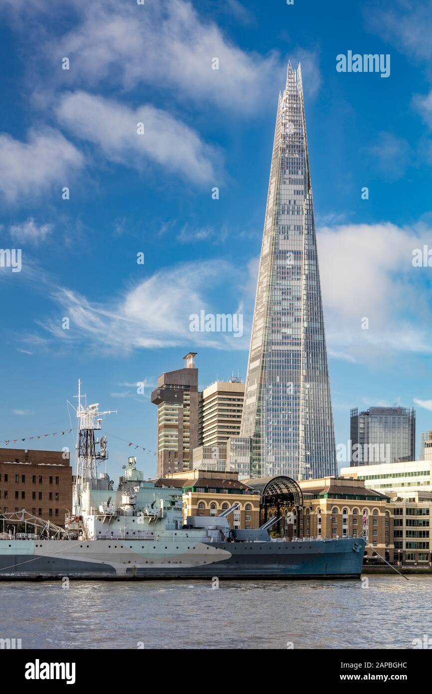 HMS Belfast - a WWII Light Cruiser - now part of the Imperial War Museum, moored below the Shard along South Bank, River Thames, London, England, UK Stock Photo