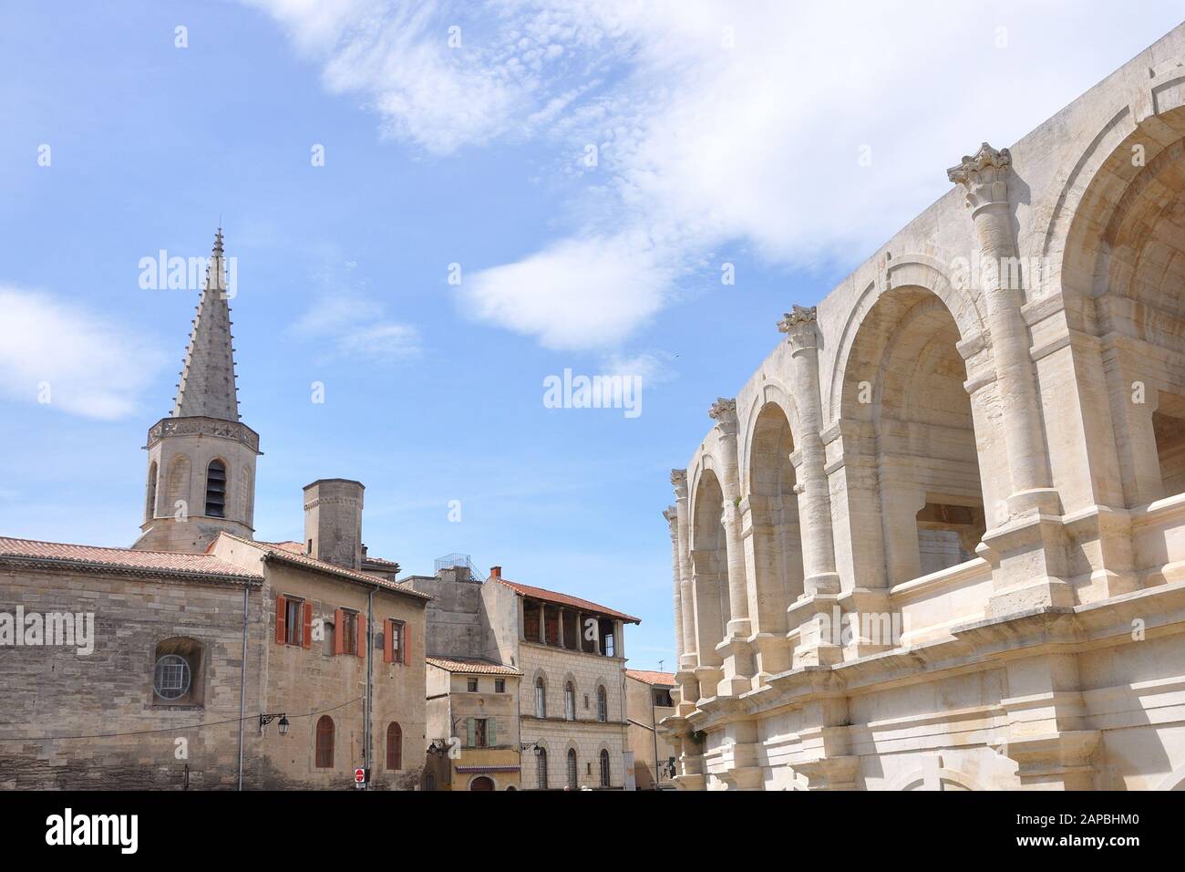 arene d'Arles, city in the south of France. bell tower and arena nearby Stock Photo