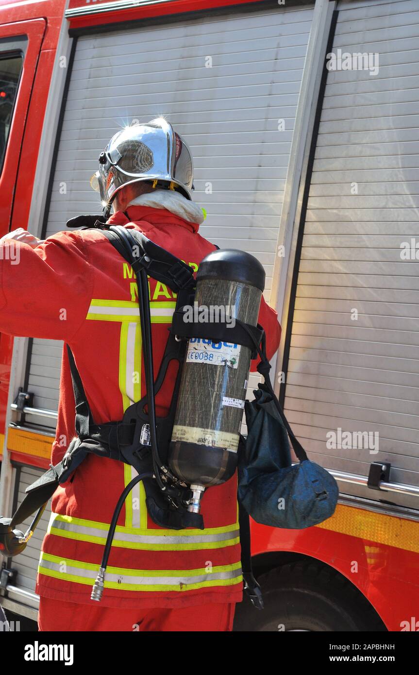 firefighter, equipped firefighter, near his truck, France Stock Photo
