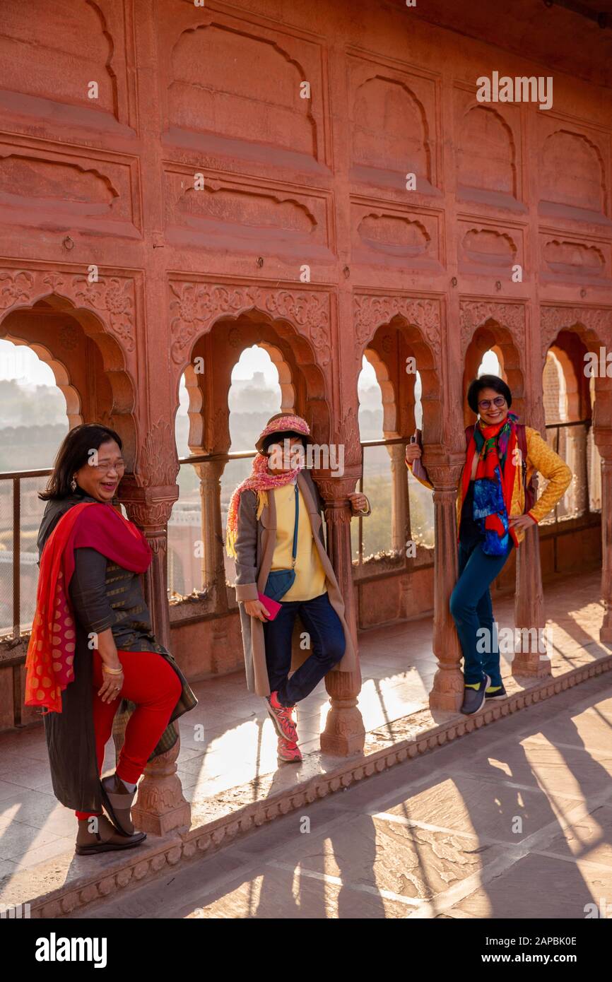 India, Rajasthan, Shekhawati, Bikaner, city centre, Junagarh Fort, Japanese tourists posing amongst pillars on rooftop terrace Stock Photo