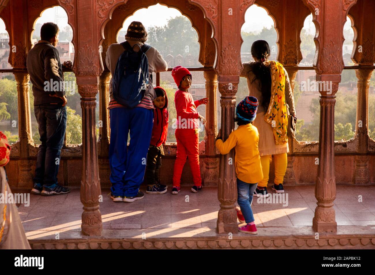India, Rajasthan, Shekhawati, Bikaner, city centre, Junagarh Fort, Indian tourist family admiring view of gardens between pillars on rooftop terrace Stock Photo