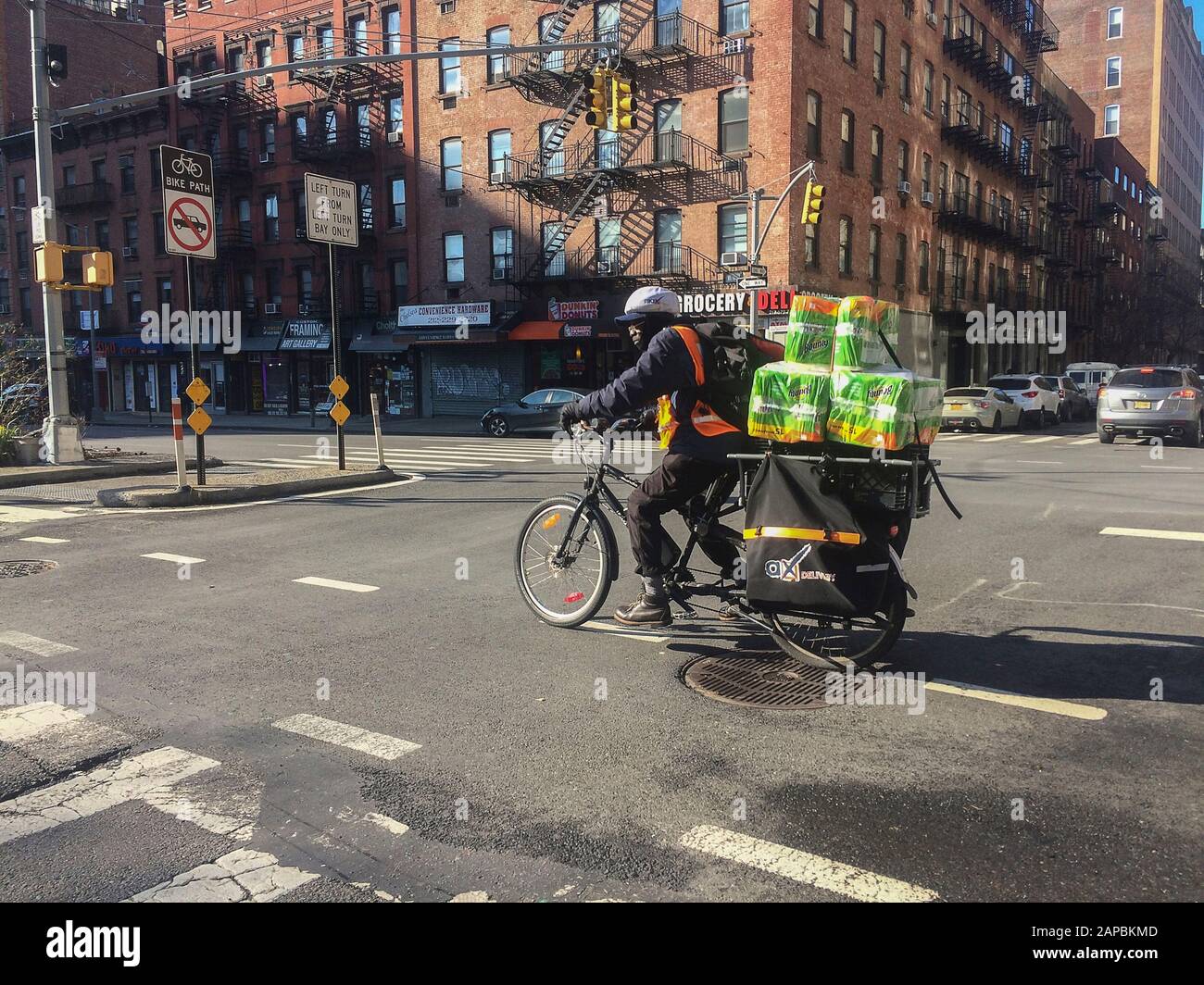 A bicycle deliveryman in the Chelsea neighborhood of New York on Monday, January 6, 2020. (© Frances M. Roberts) Stock Photo