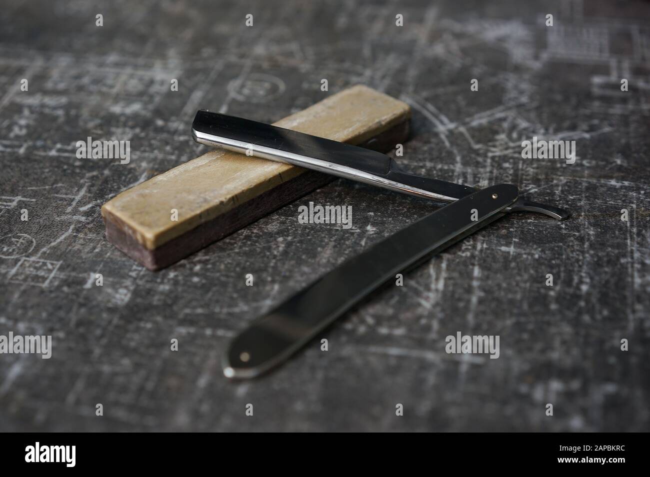 traditional razor with a steel handle on a sharpening stone Stock Photo Alamy