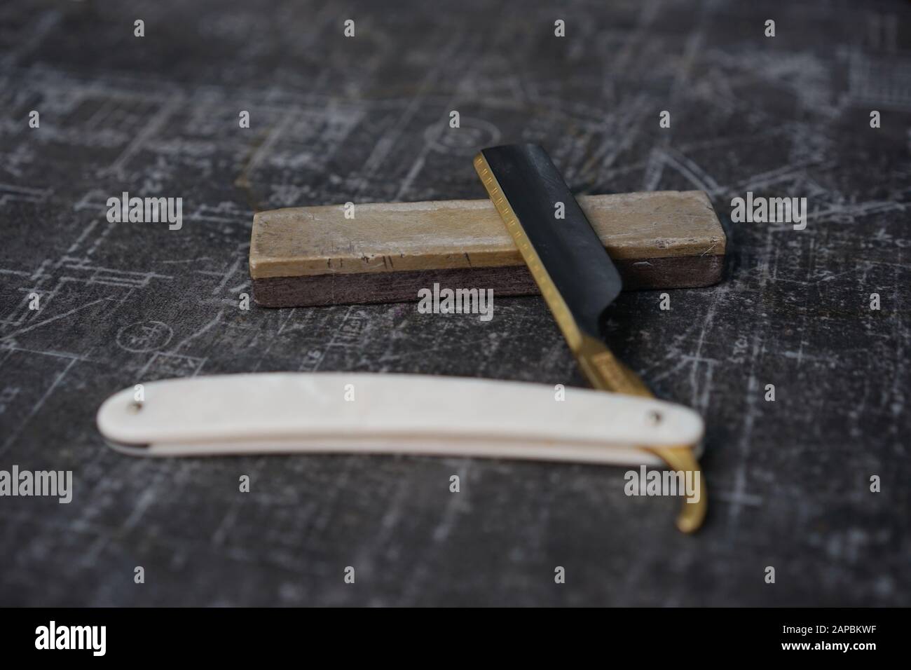 traditional razor with a gilded blade on a sharpening stone Stock Photo Alamy