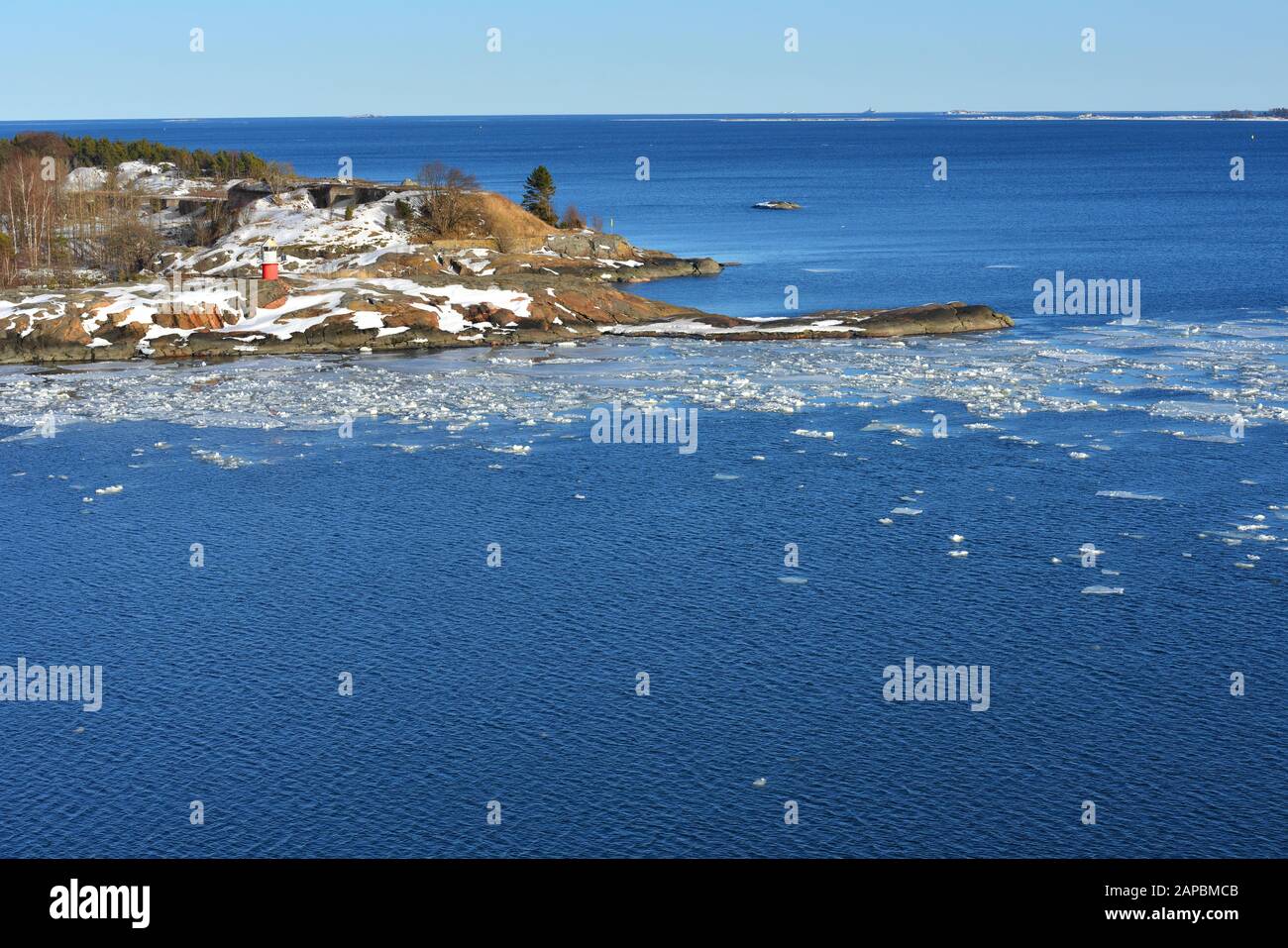 Baltic Sea with floating ice near island coast of Helsinki Archipelago. Finland Stock Photo
