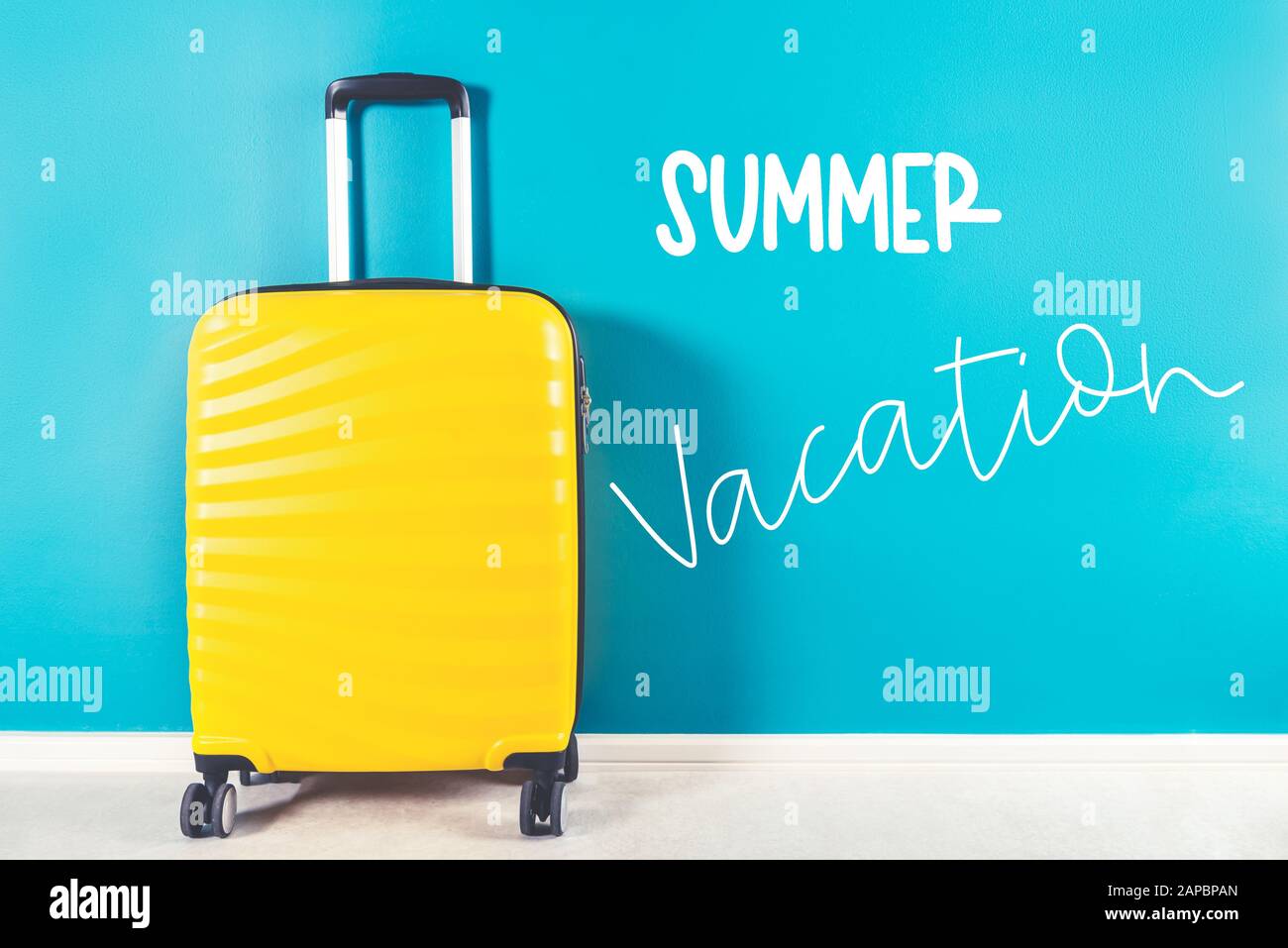 Summer Vacation words. Bright and stylish cabin size suitcase against