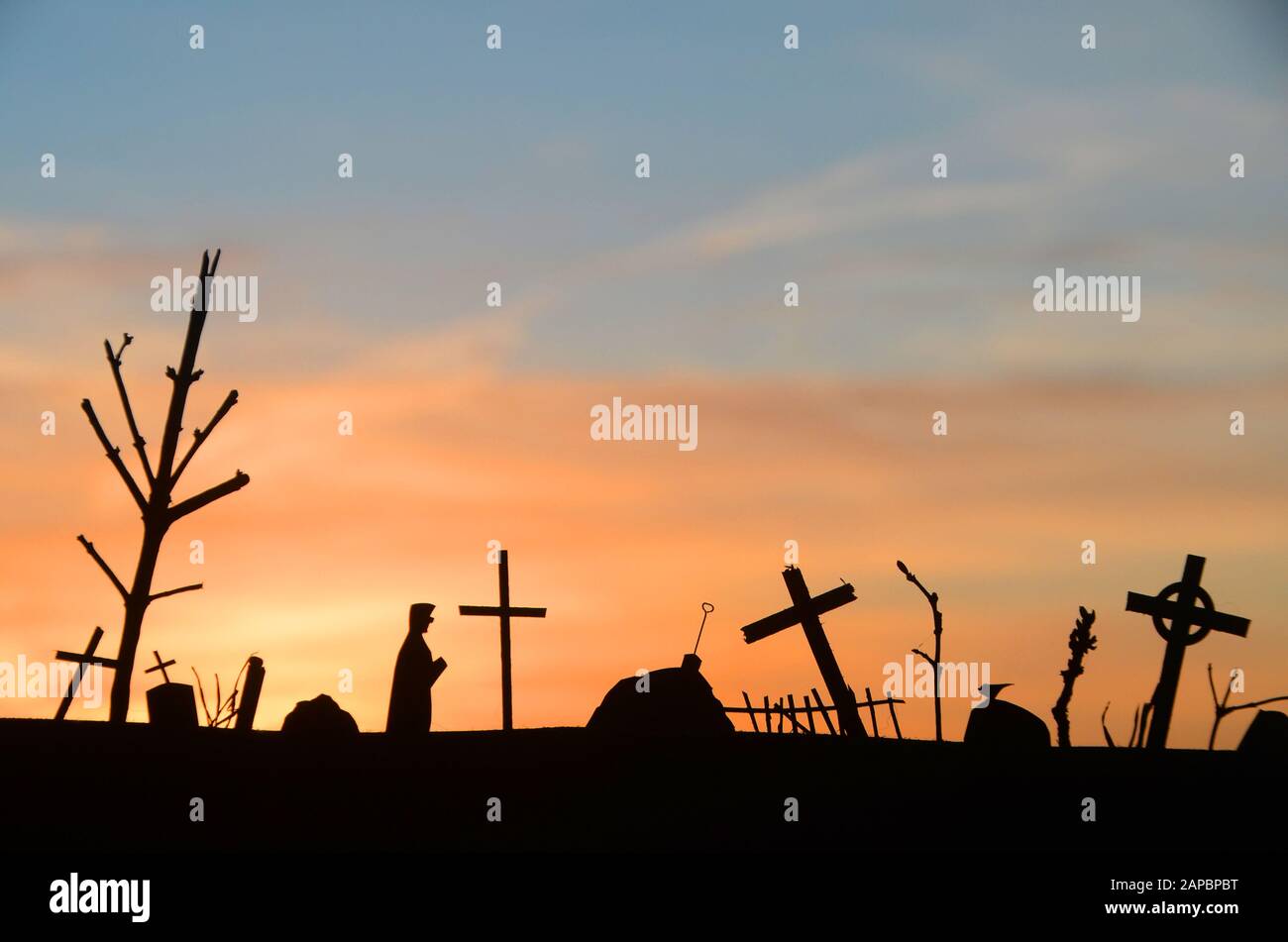 Silhouette of decayed graveyard with tilted crosses and tombstones in ...
