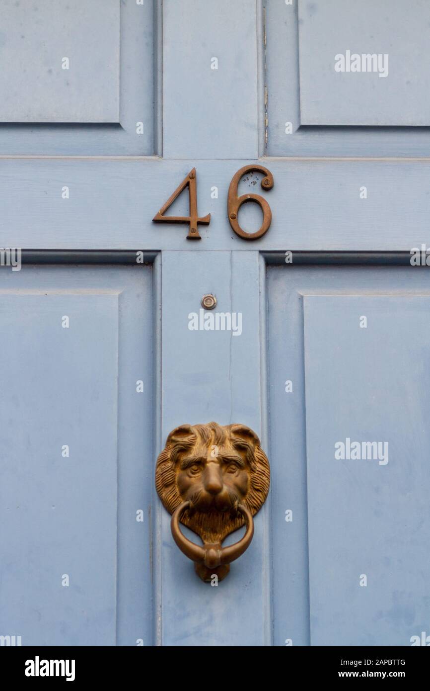 House number 46 with ornate bronze door knocker Stock Photo